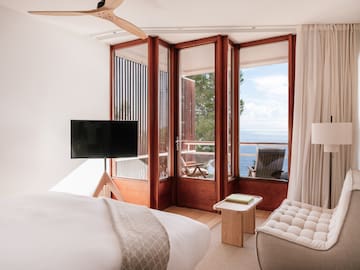 a bedroom with a television and a chair