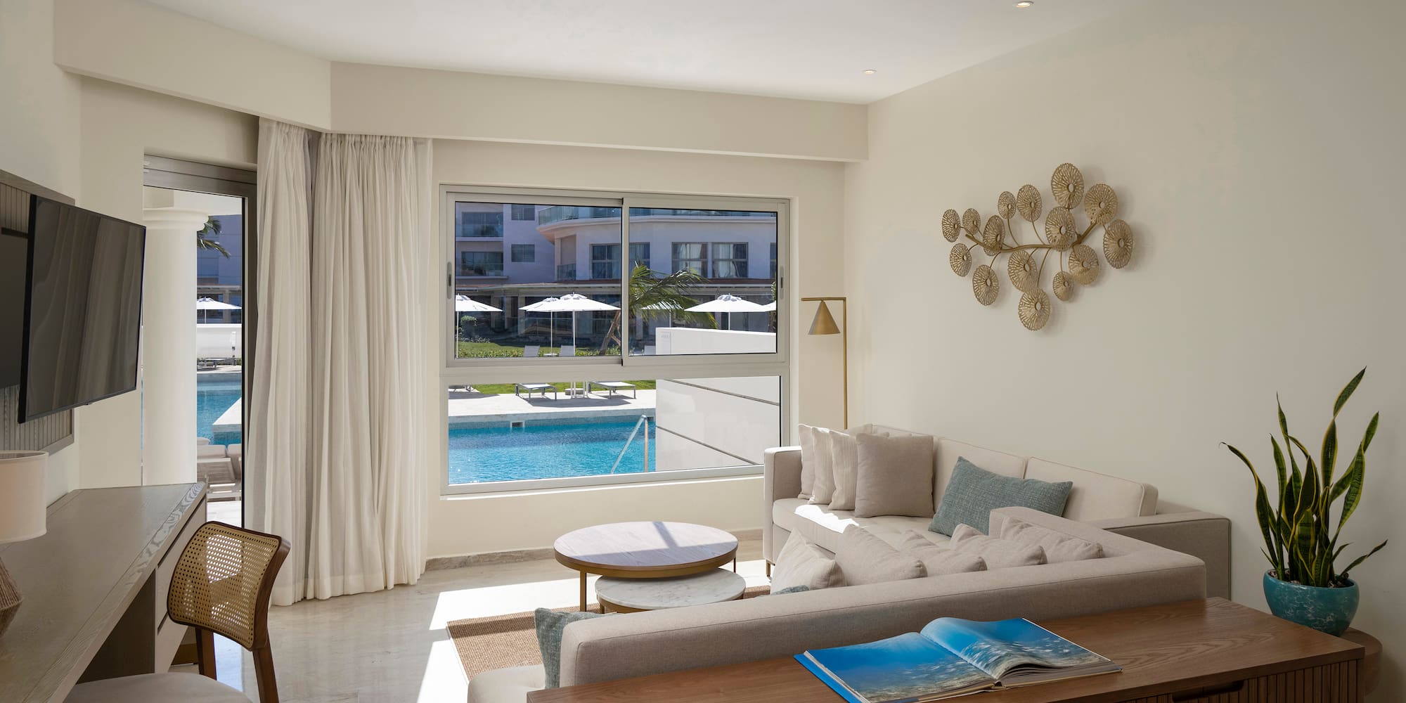 a living room with a pool in the background