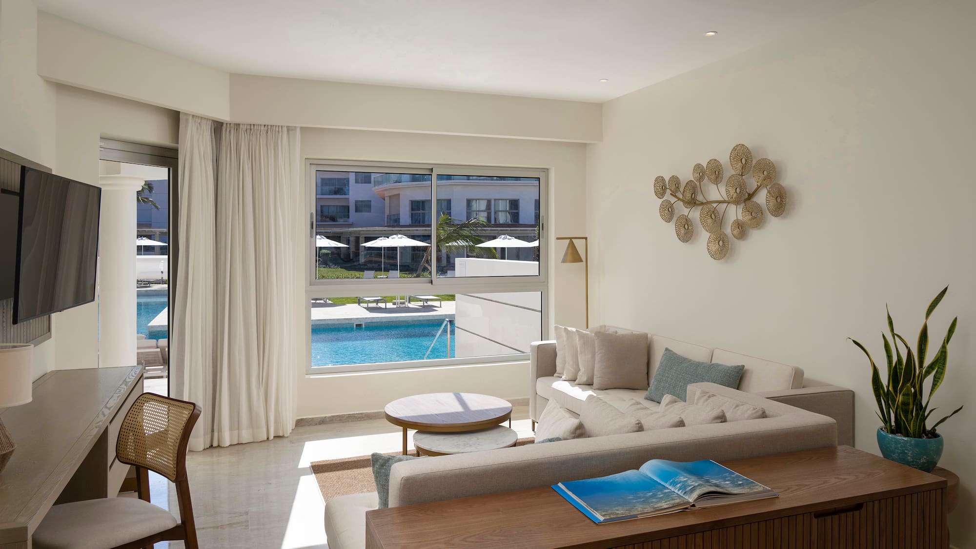 a living room with a pool in the background