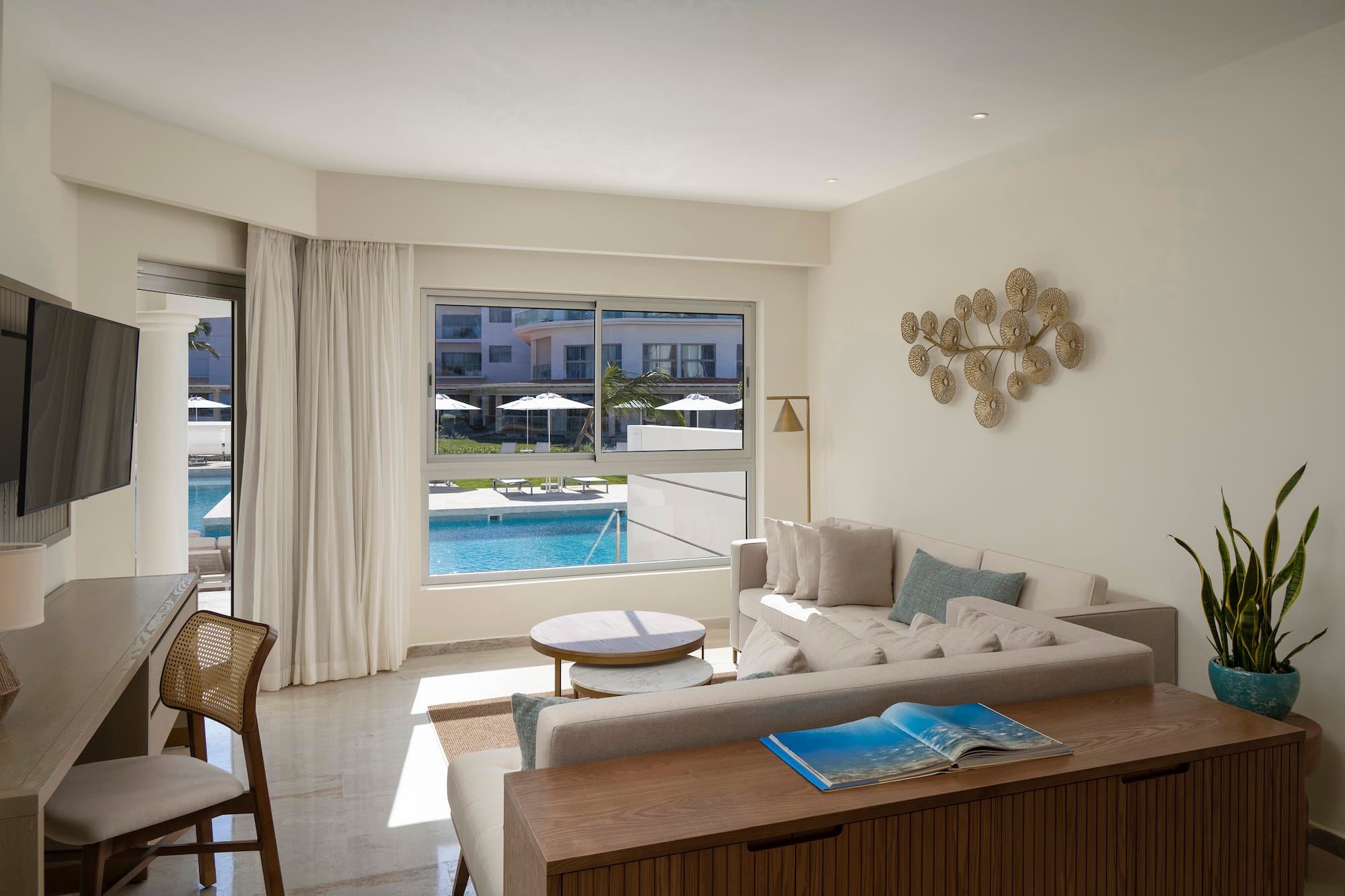 a living room with a pool in the background