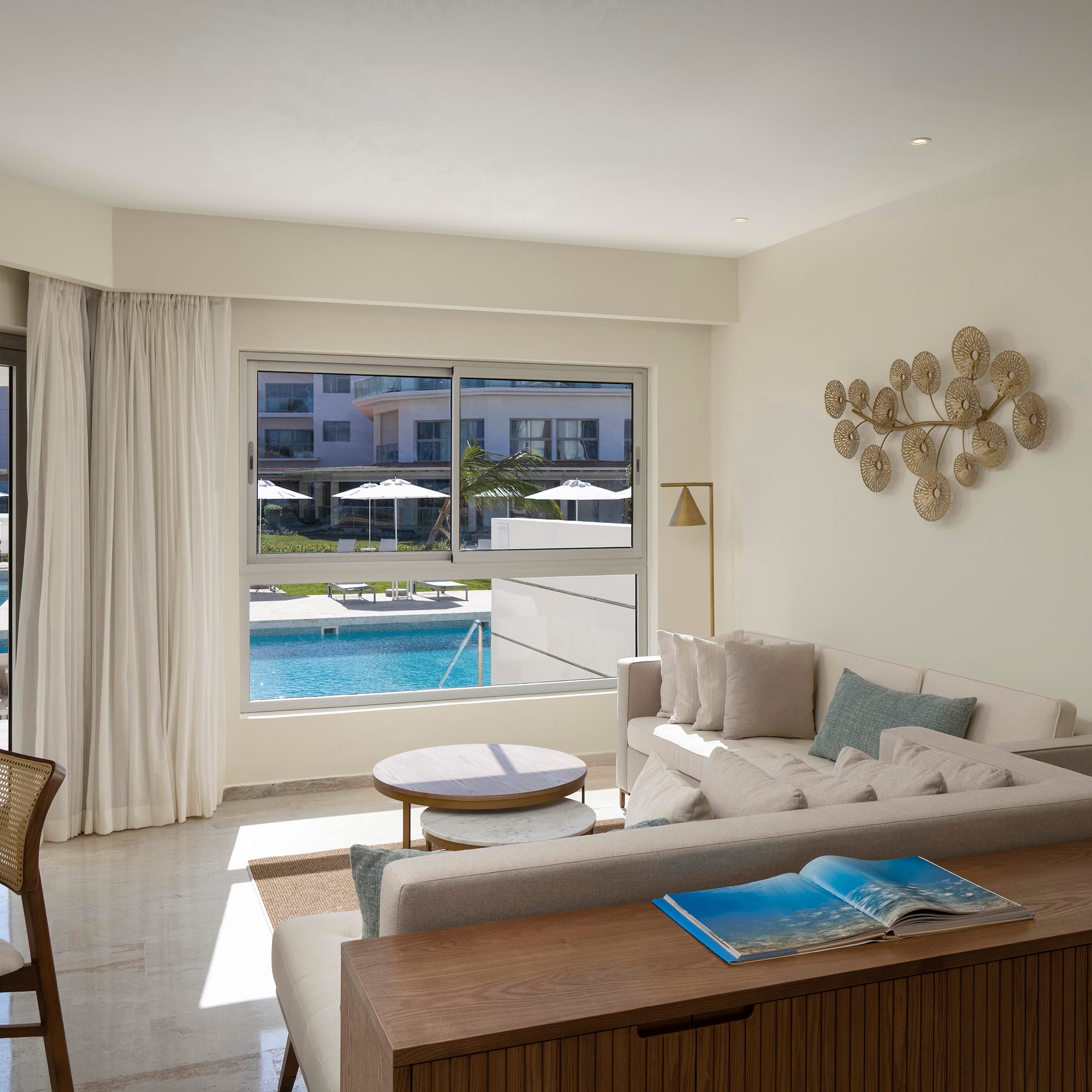 a living room with a pool in the background