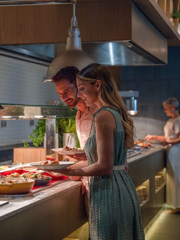 a man and woman standing in a restaurant