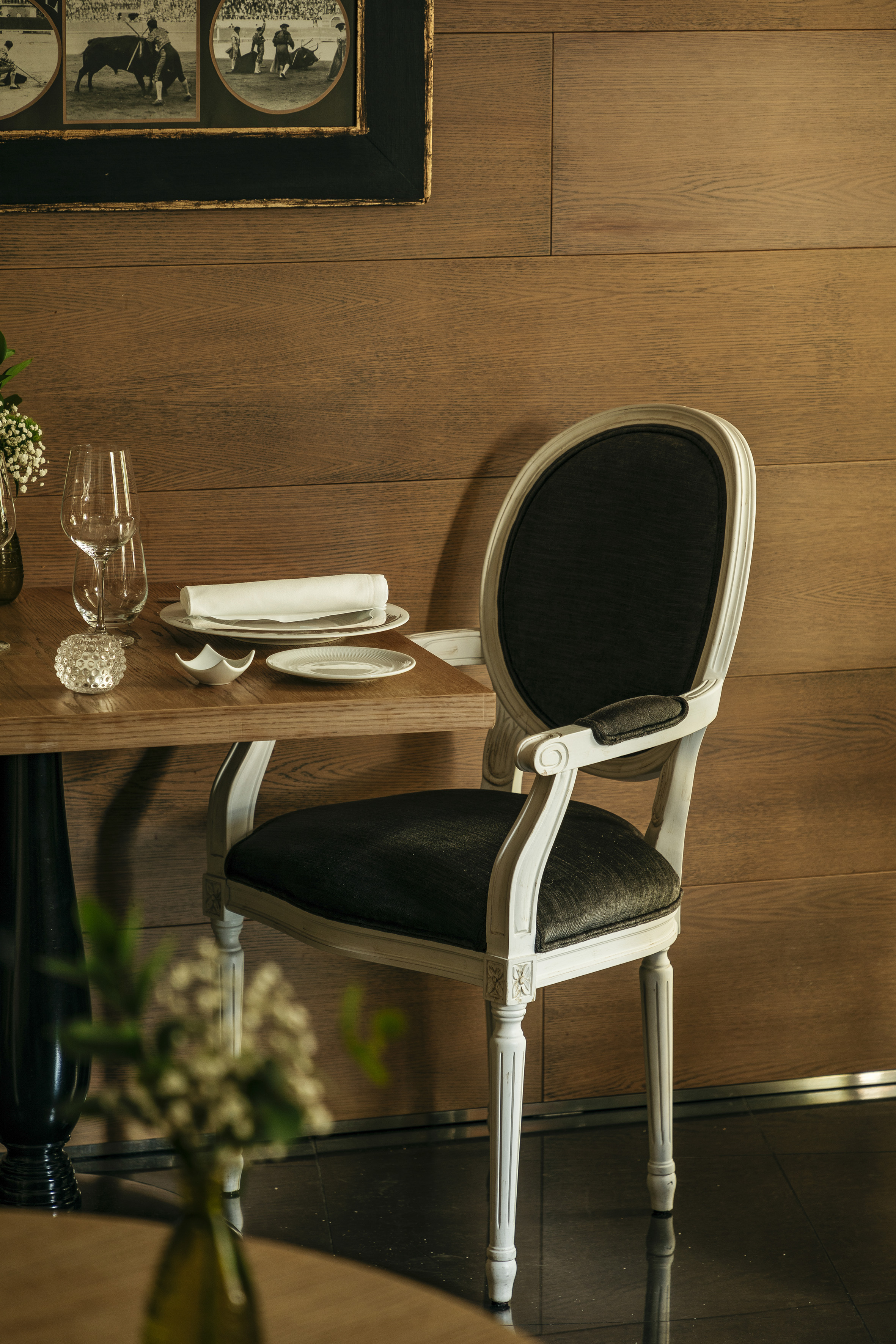 a chair and table with plates and glasses on it
