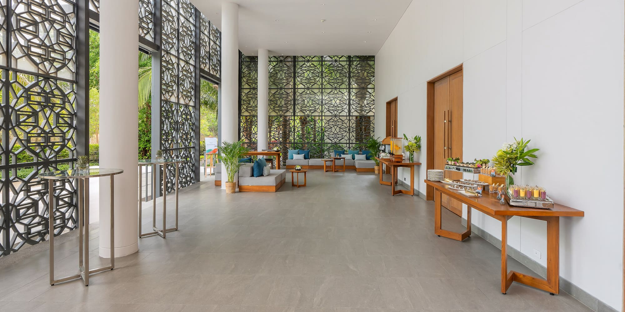 a room with a large window and a wall with plants