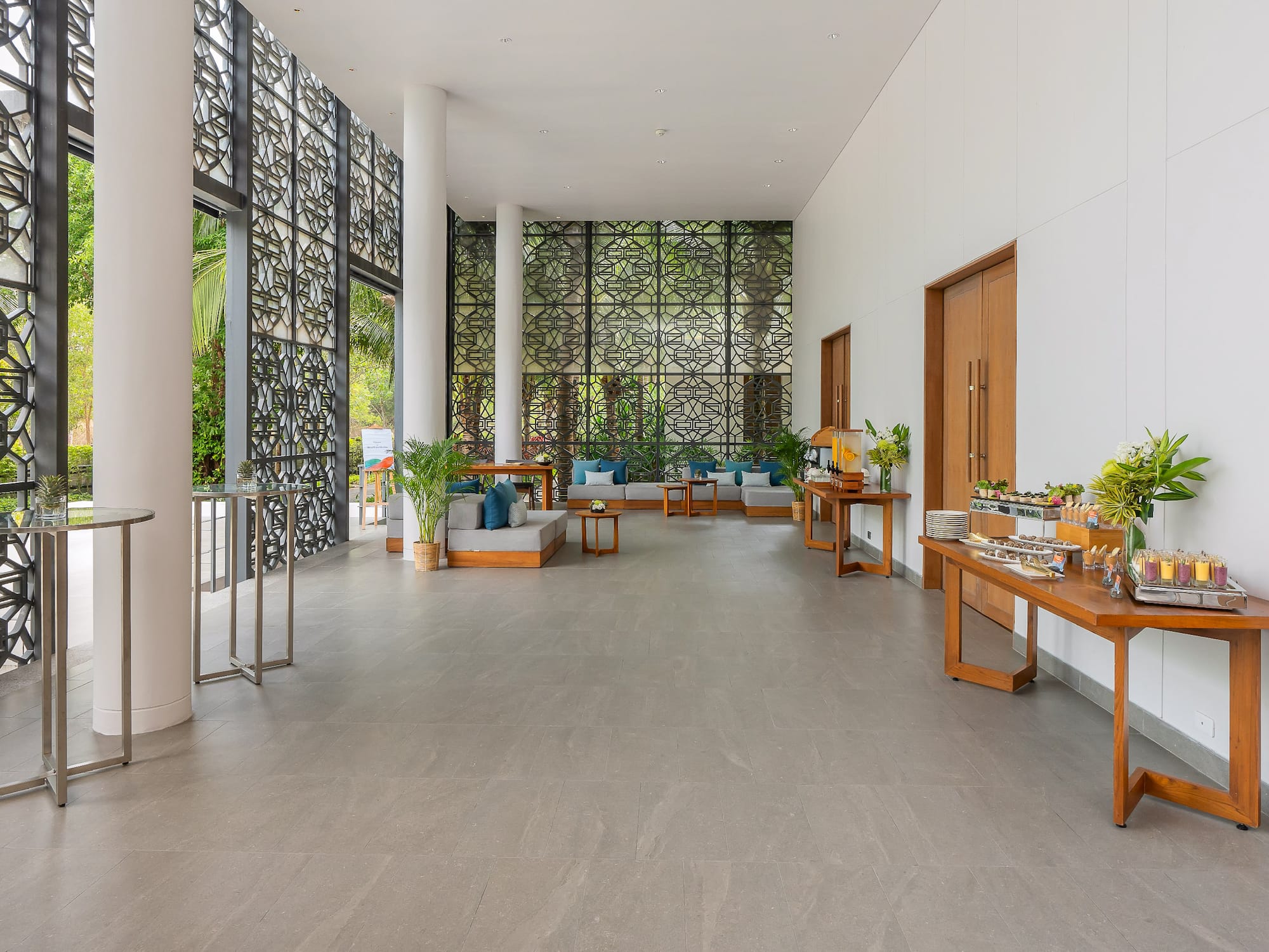 a room with a large window and a wall with plants