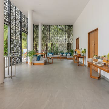 a room with a large window and a wall with plants