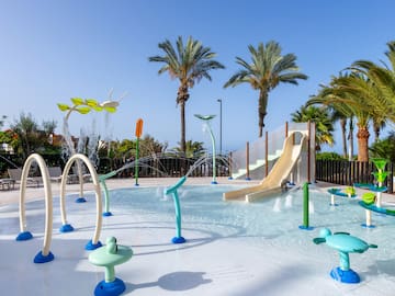 a water park with a slide and trees