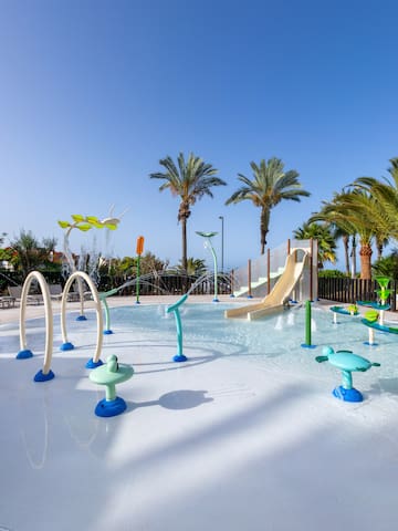 a water park with a slide and trees