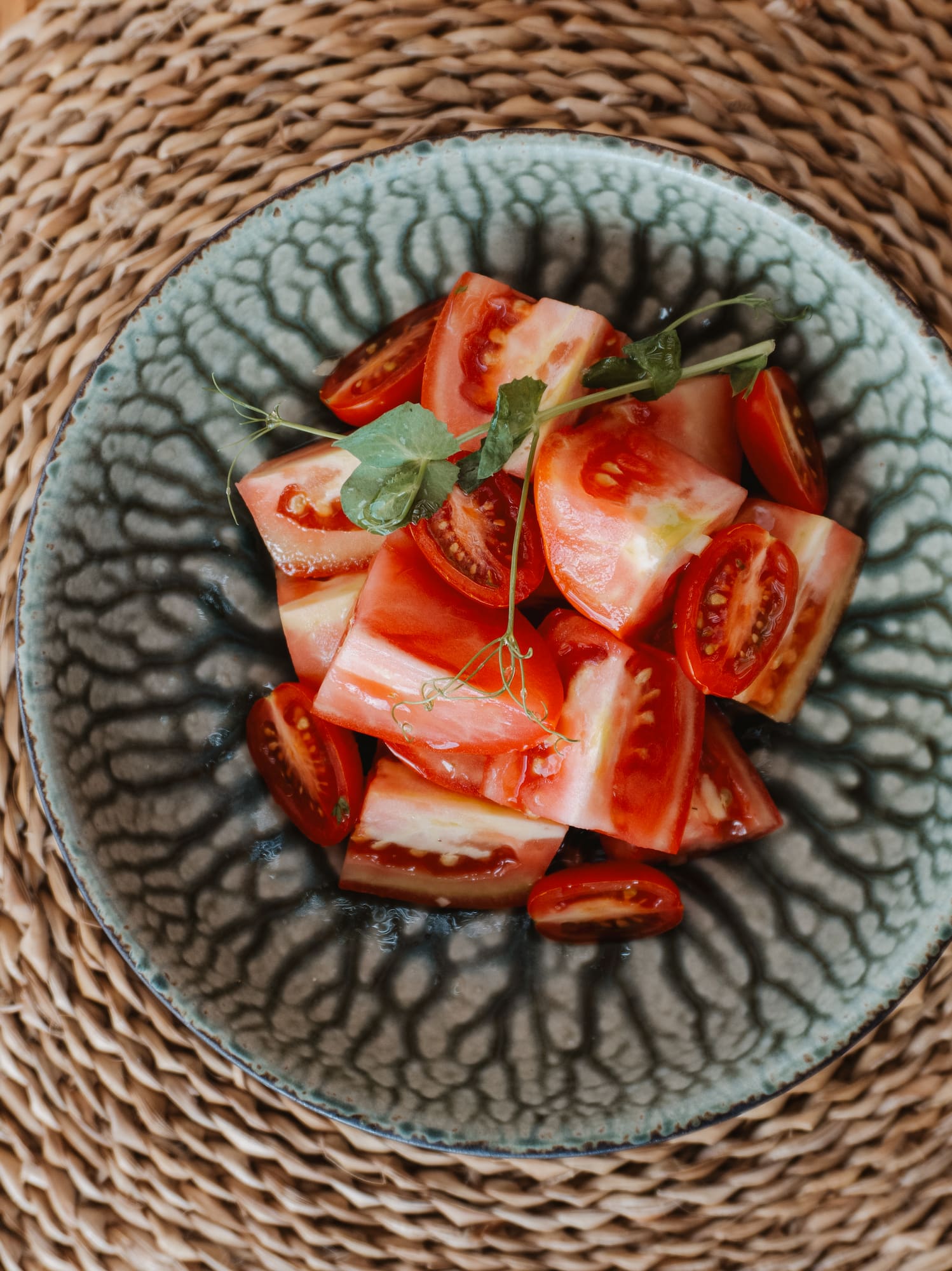 a bowl of tomatoes on a table