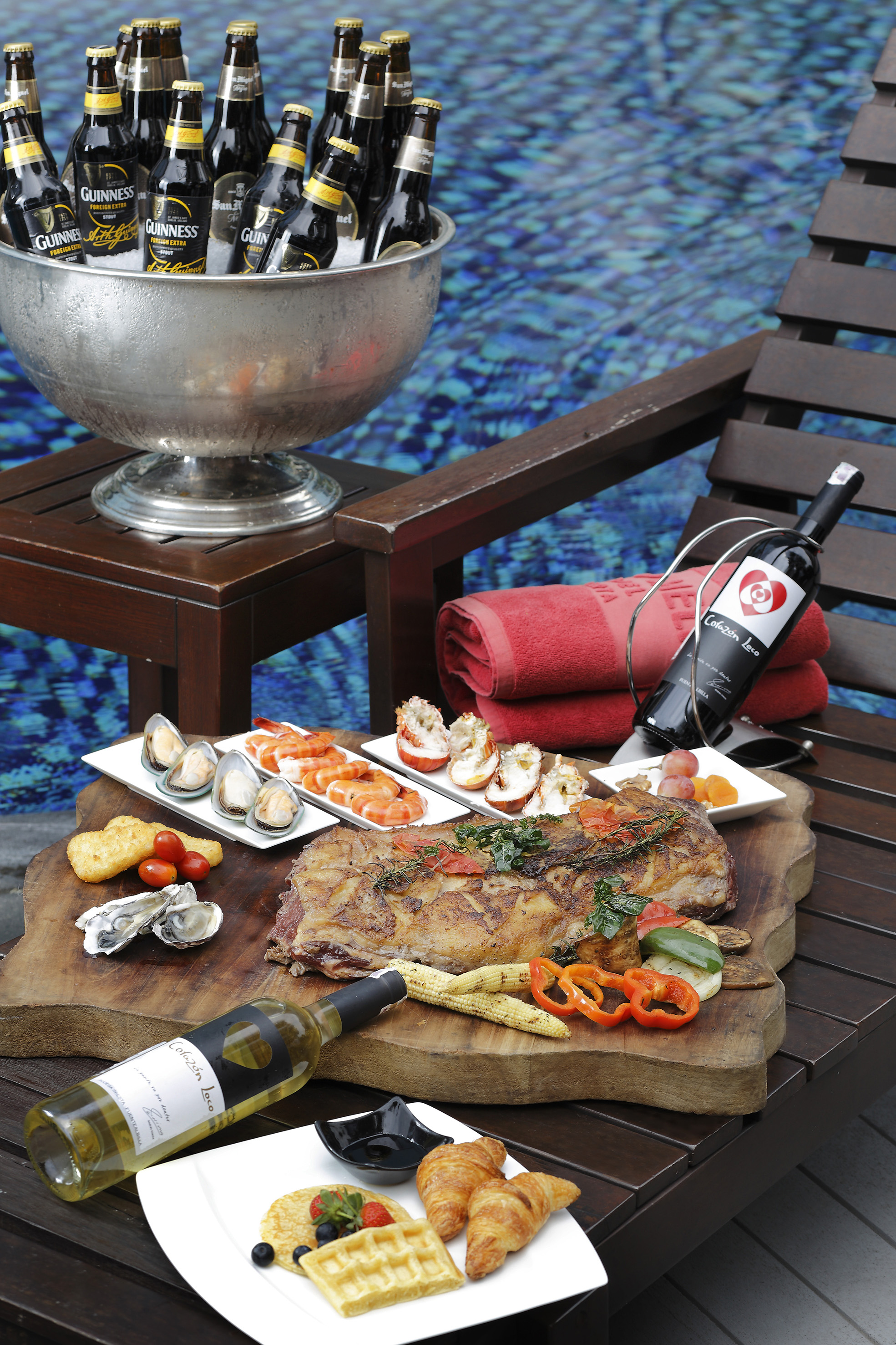 Luxury poolside spread: grilled meat, seafood, beer, wine, and gourmet breakfast.