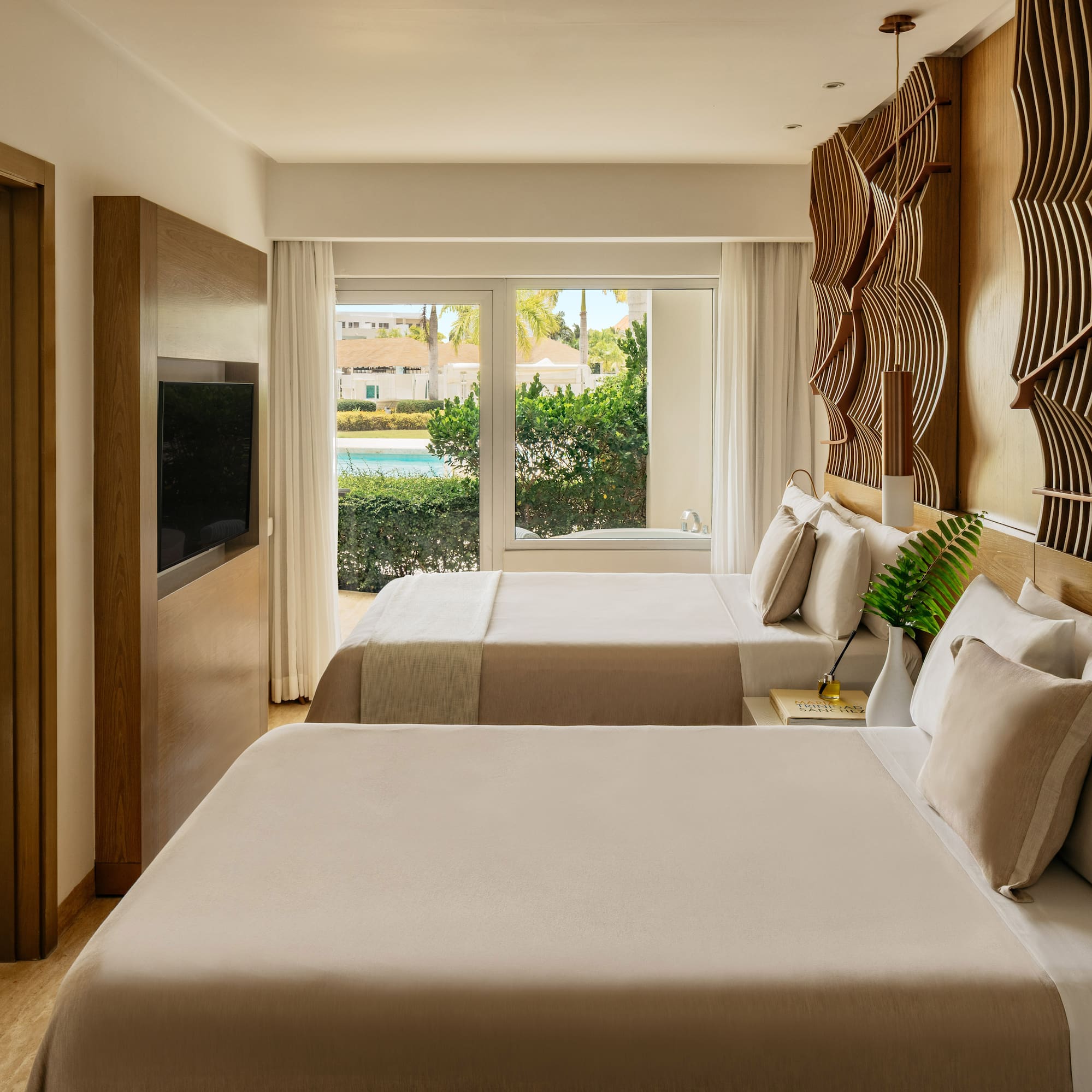 Luxury hotel room with two beds, pool view, and modern wooden decor.
