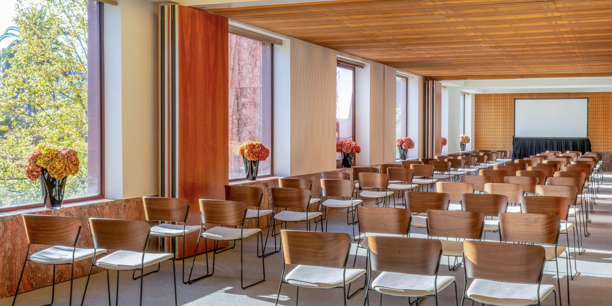 a room with chairs and flowers