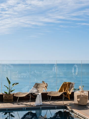 chairs on a deck overlooking the ocean