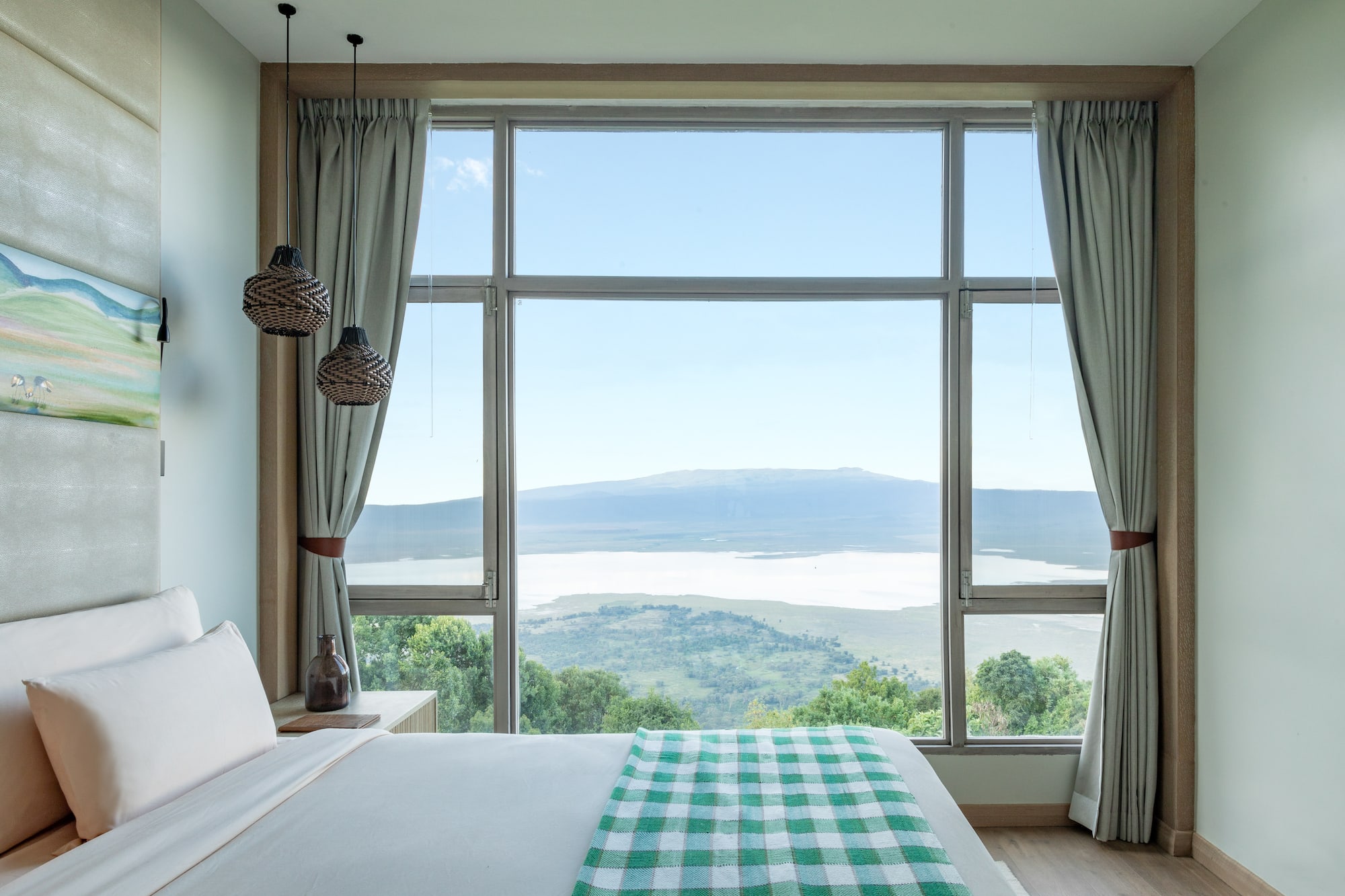 a bedroom with a view of a mountain and a lake