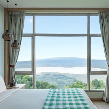 a bedroom with a view of a mountain and a lake