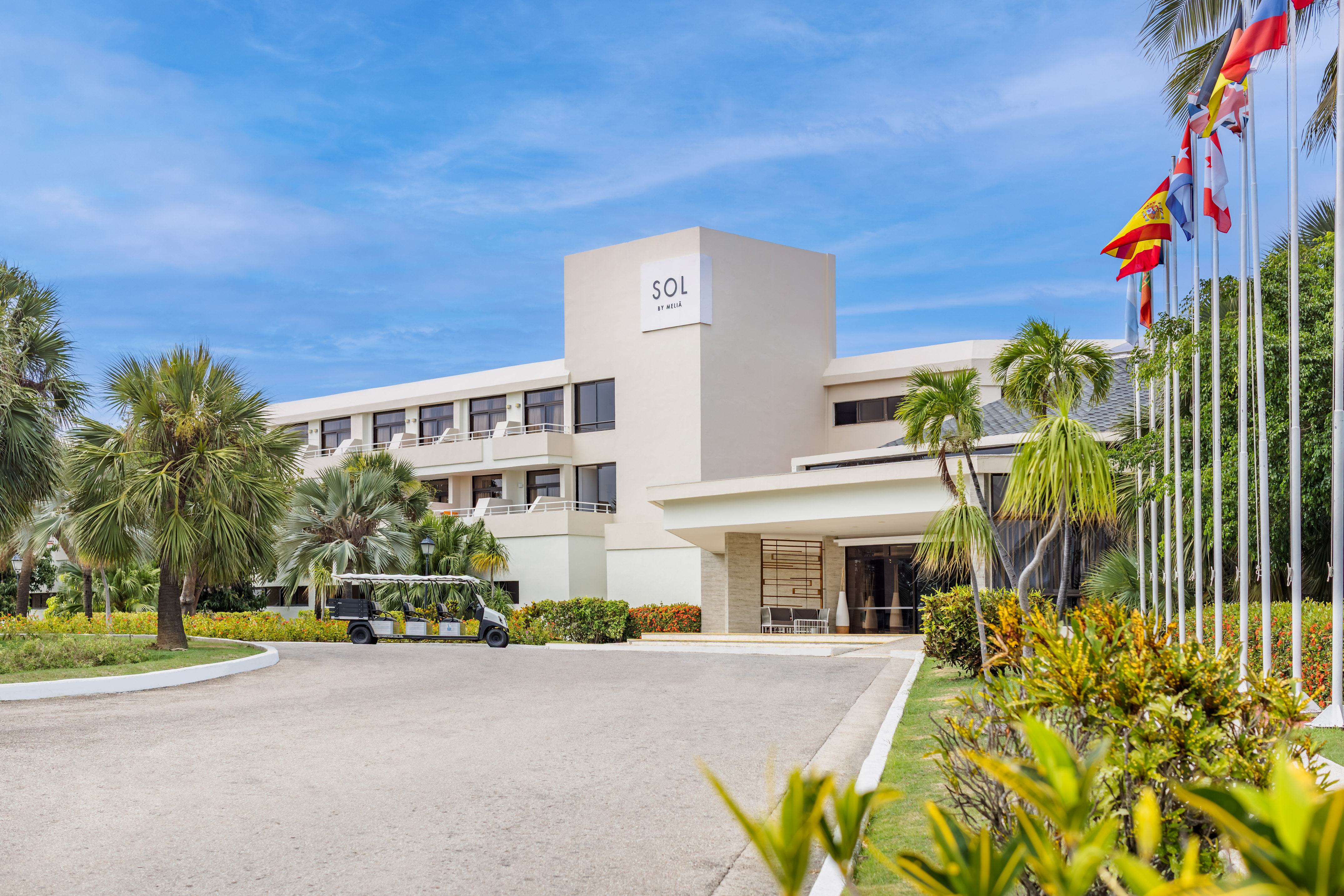 a building with a golf cart and palm trees