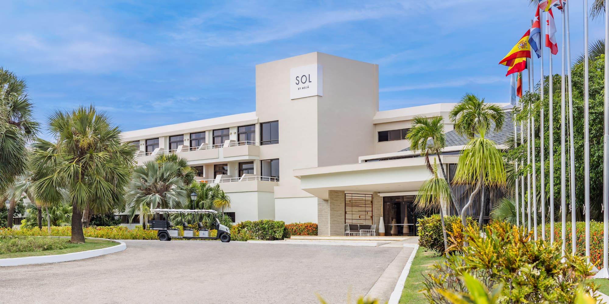a building with a golf cart and palm trees