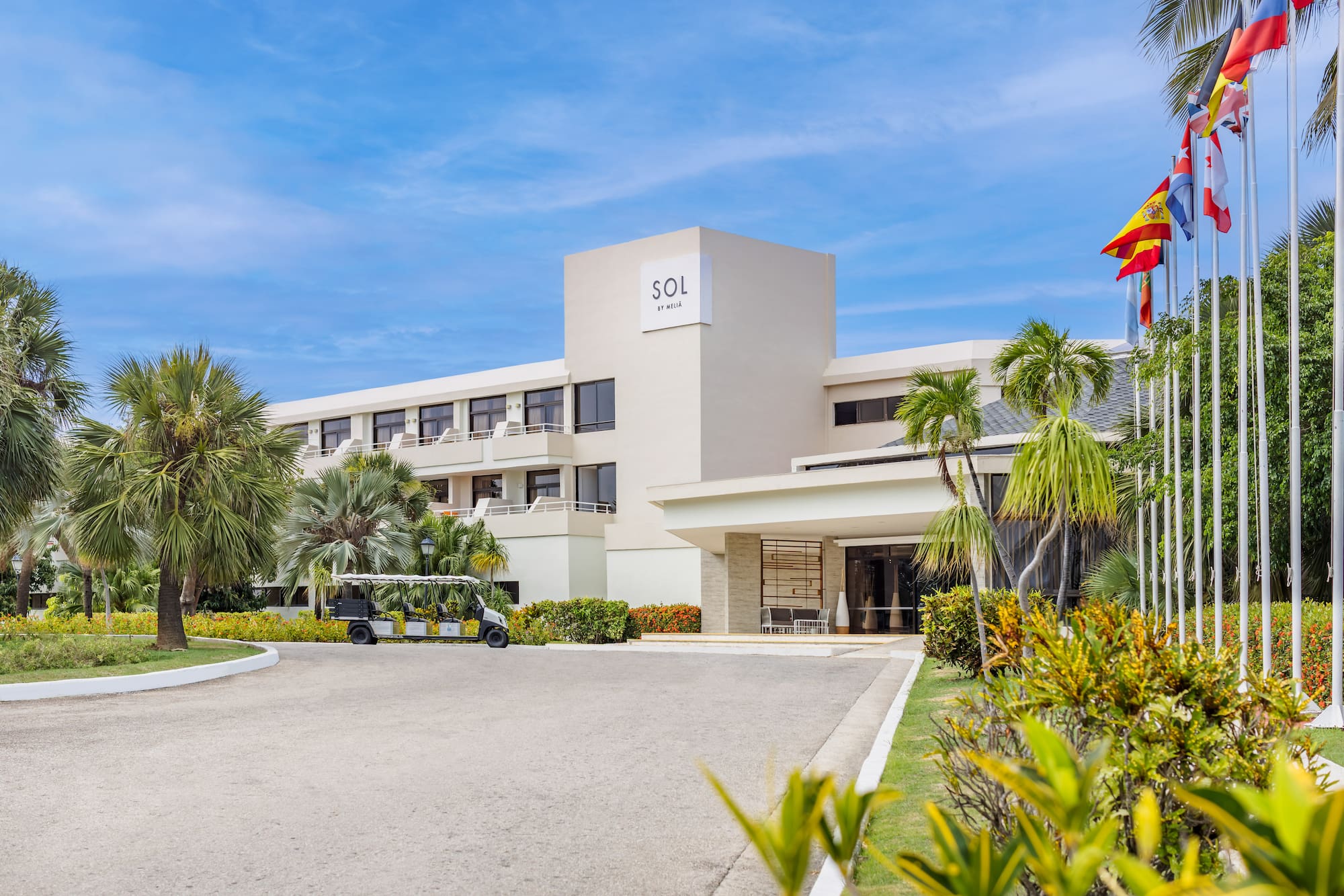 a building with a golf cart and palm trees
