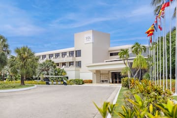 a building with a golf cart and palm trees