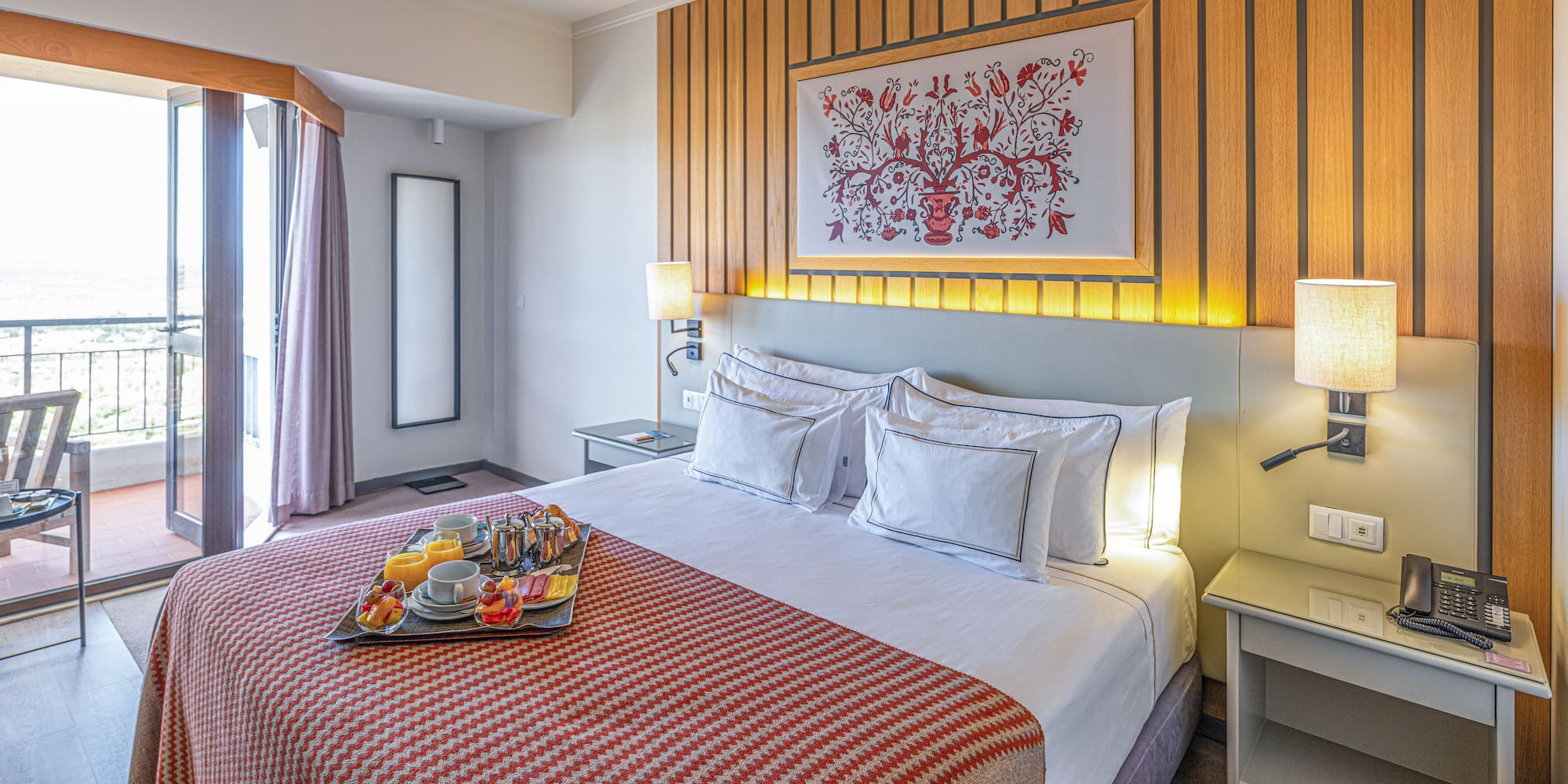 a bed with a tray of food on it