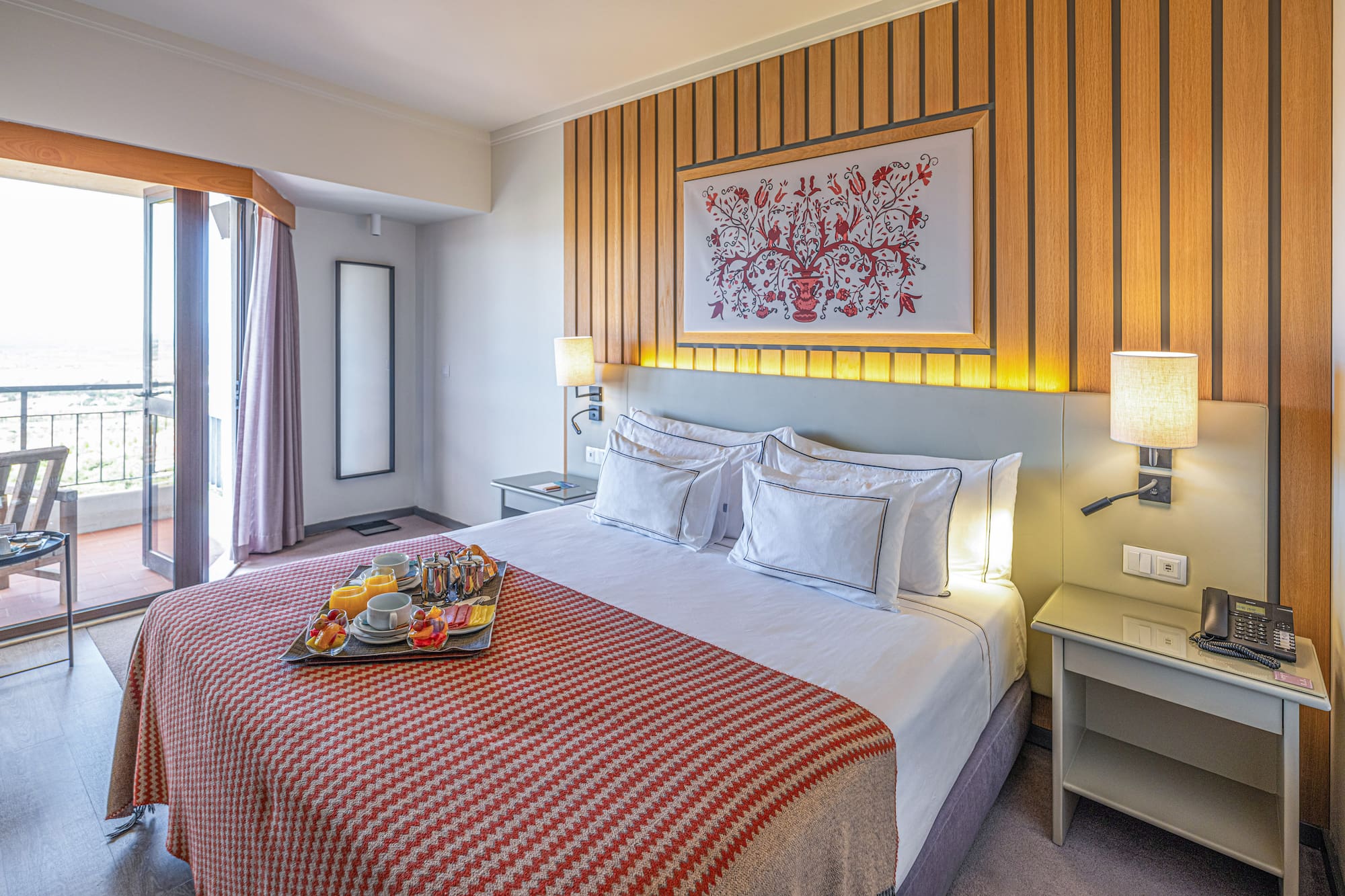 a bed with a tray of food on it