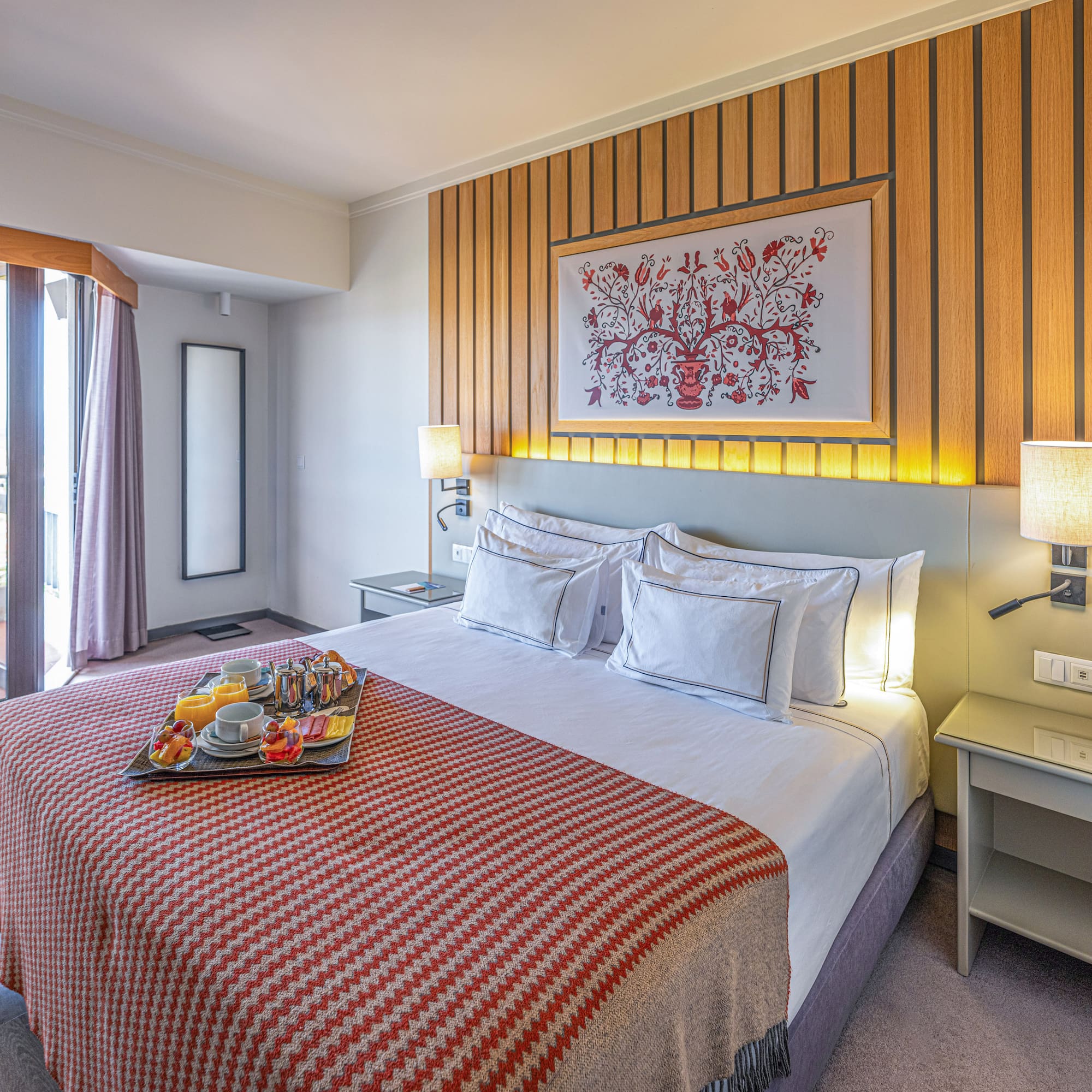 a bed with a tray of food on it