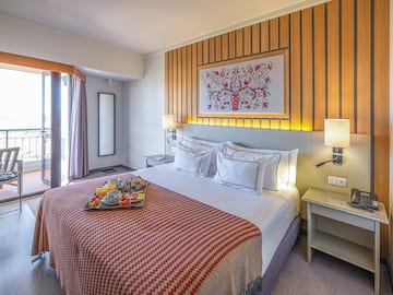 a bed with a tray of food on it