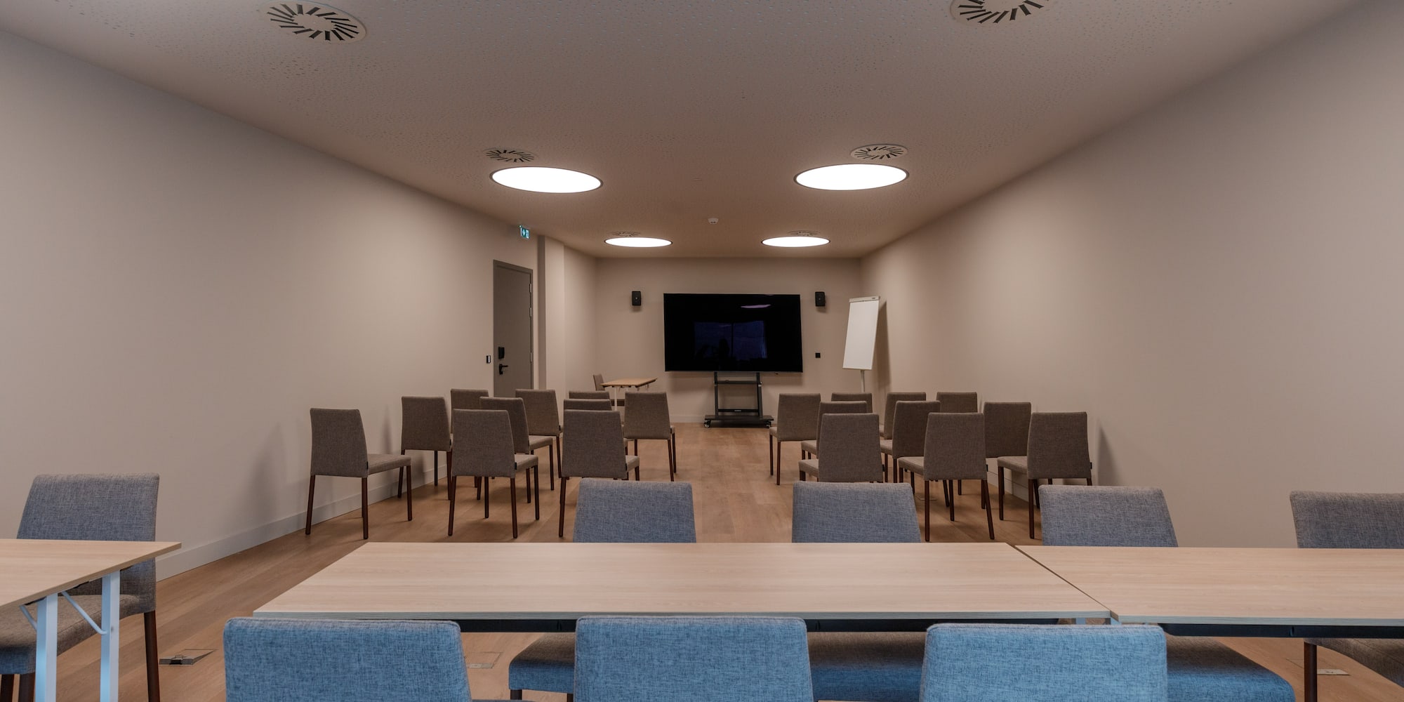 a room with chairs and a screen