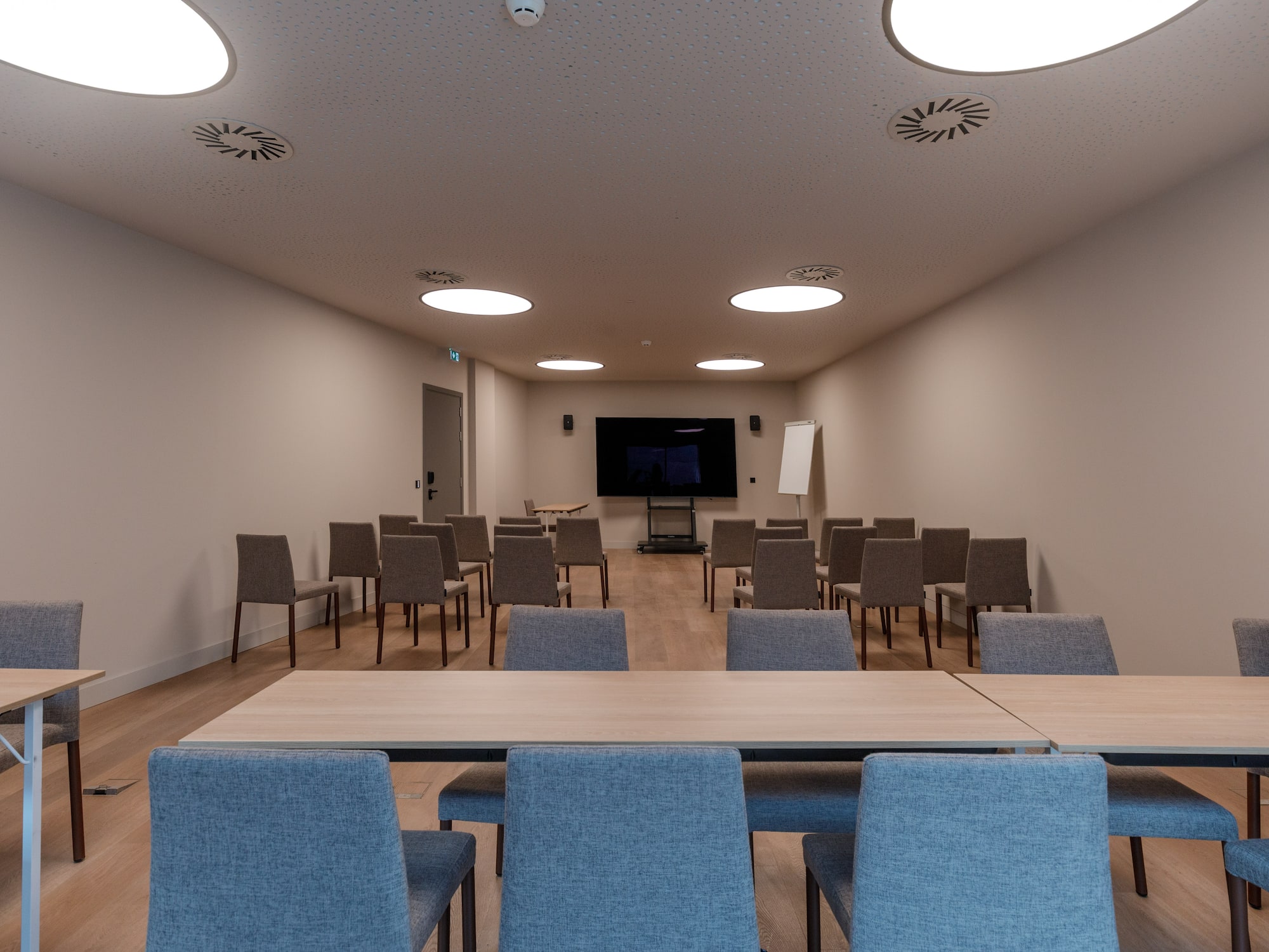 a room with chairs and a screen