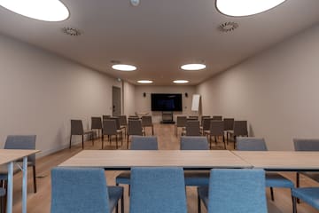 a room with chairs and a screen