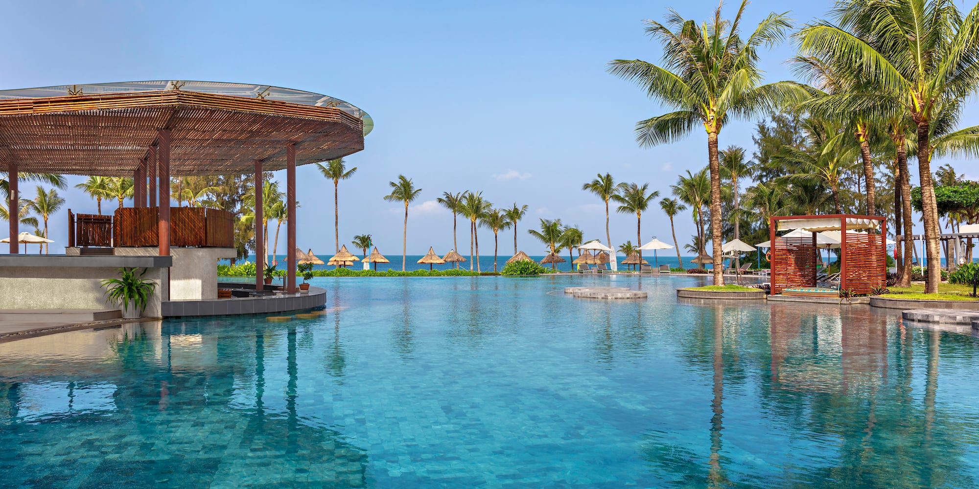 a pool with a bar and umbrellas