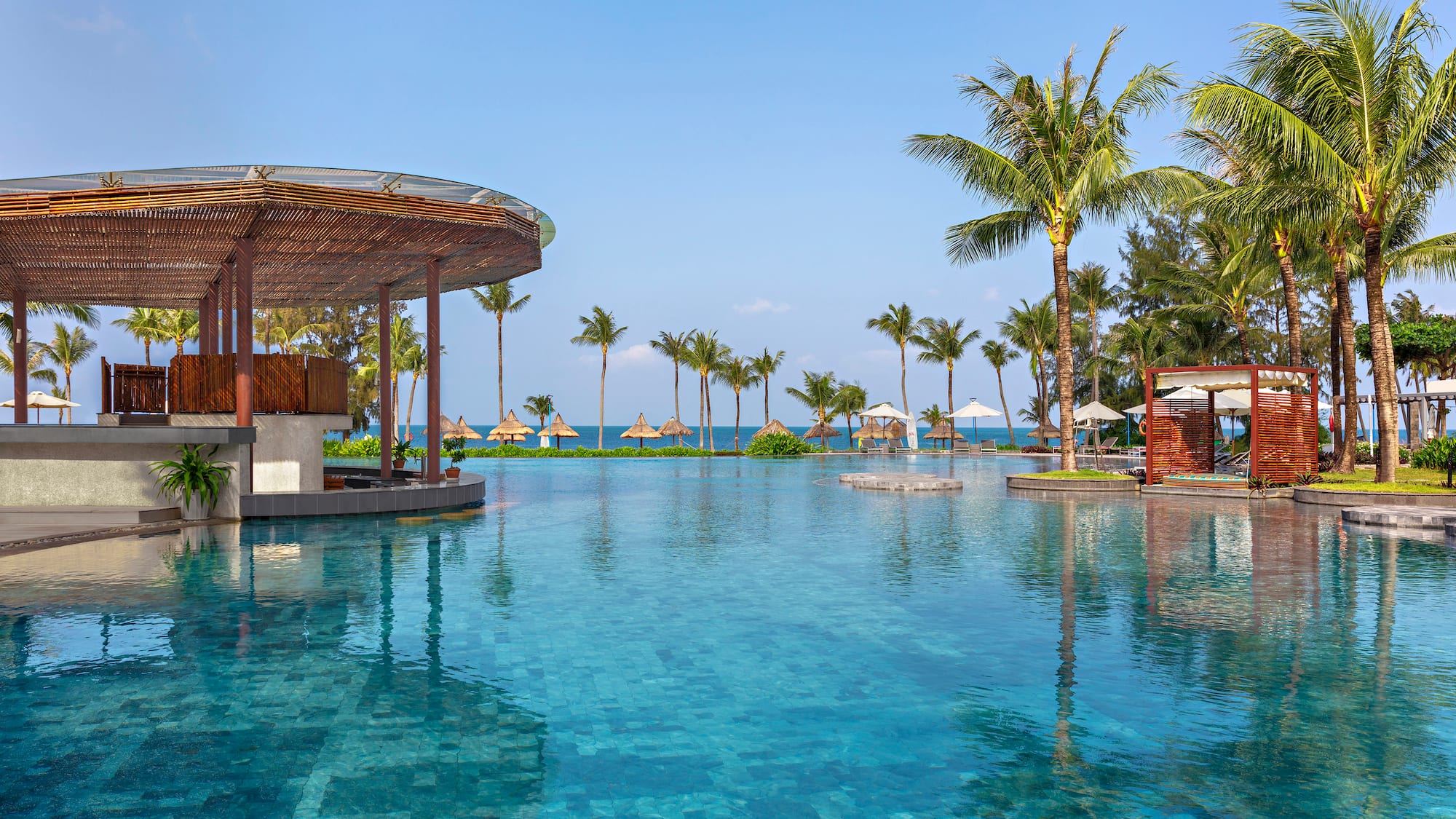 a pool with a bar and umbrellas