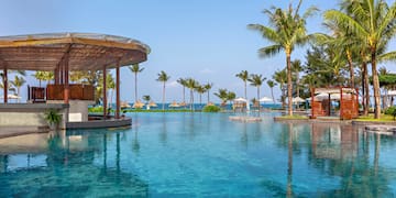 a pool with a bar and umbrellas
