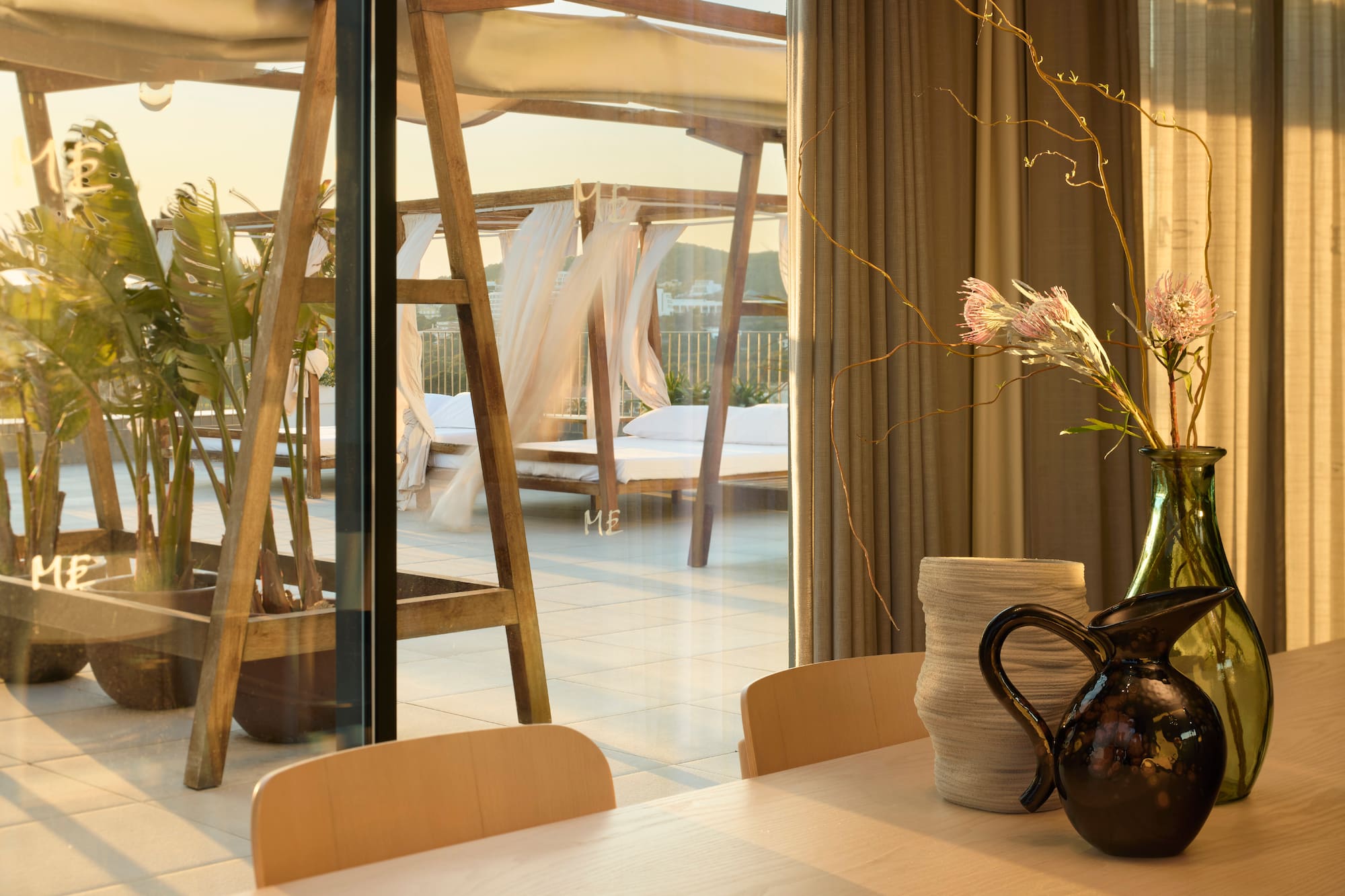 a table with chairs and vases on it