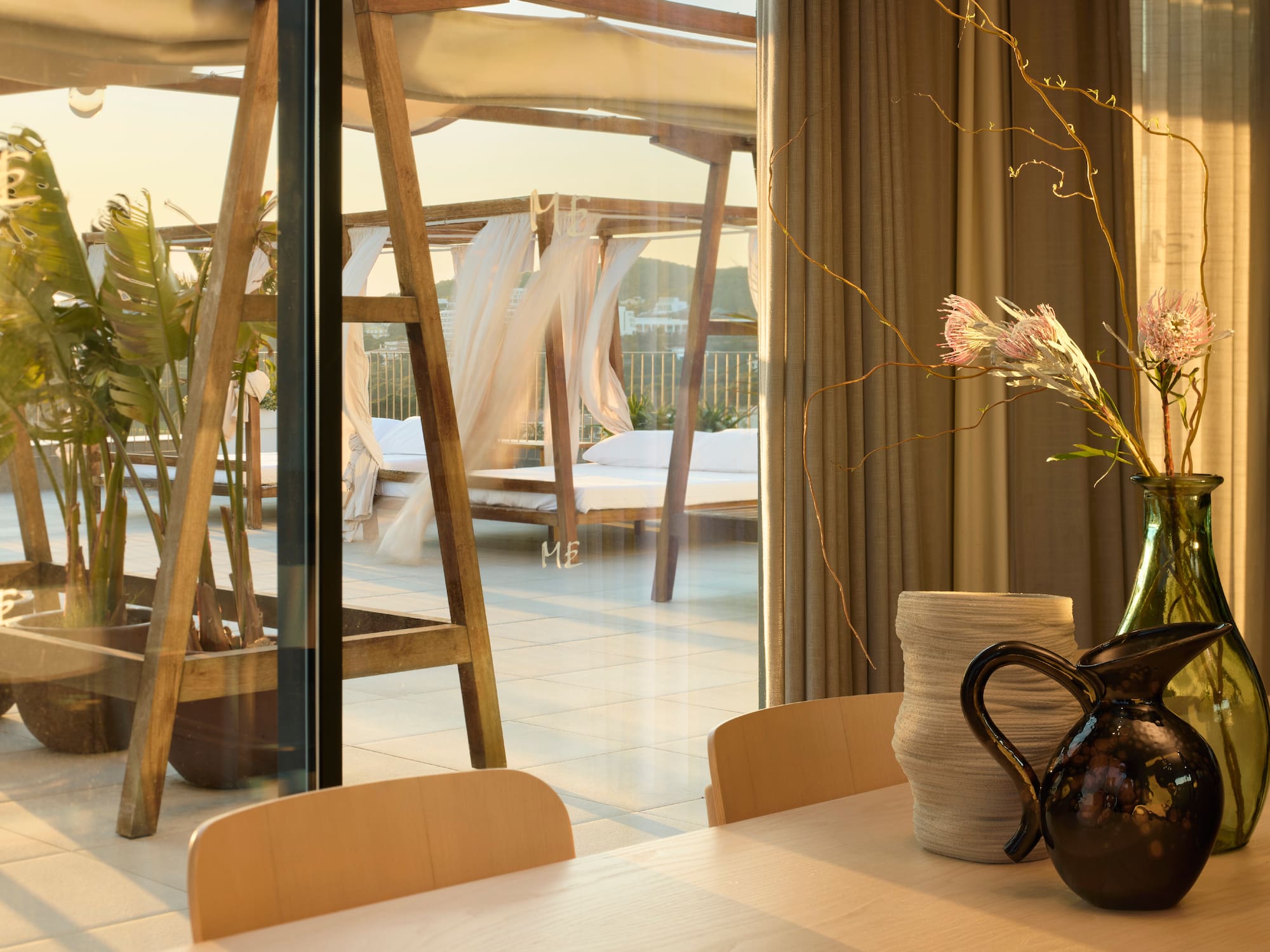 a table with chairs and vases on it