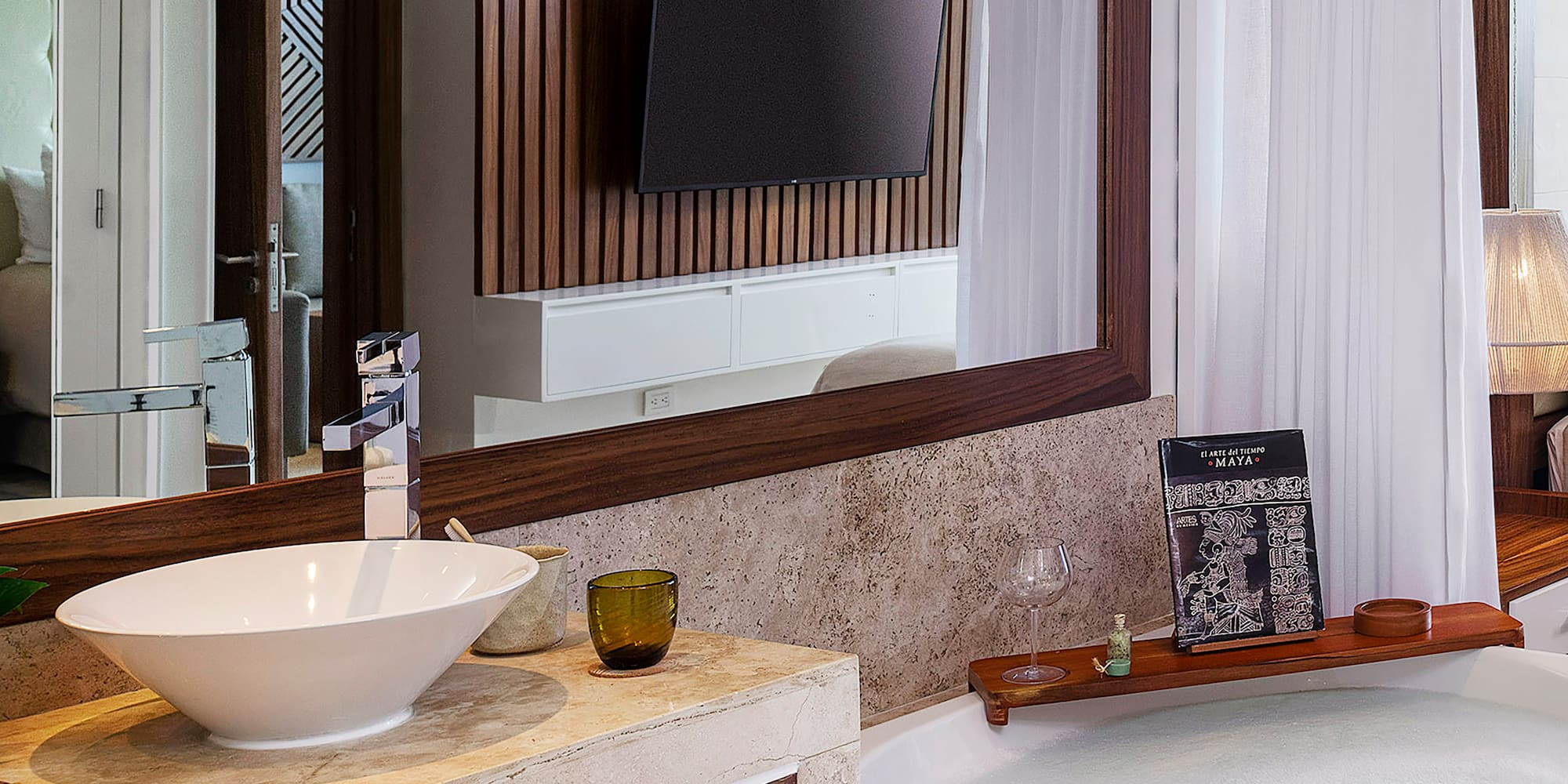 a bathroom with a large mirror and a tub