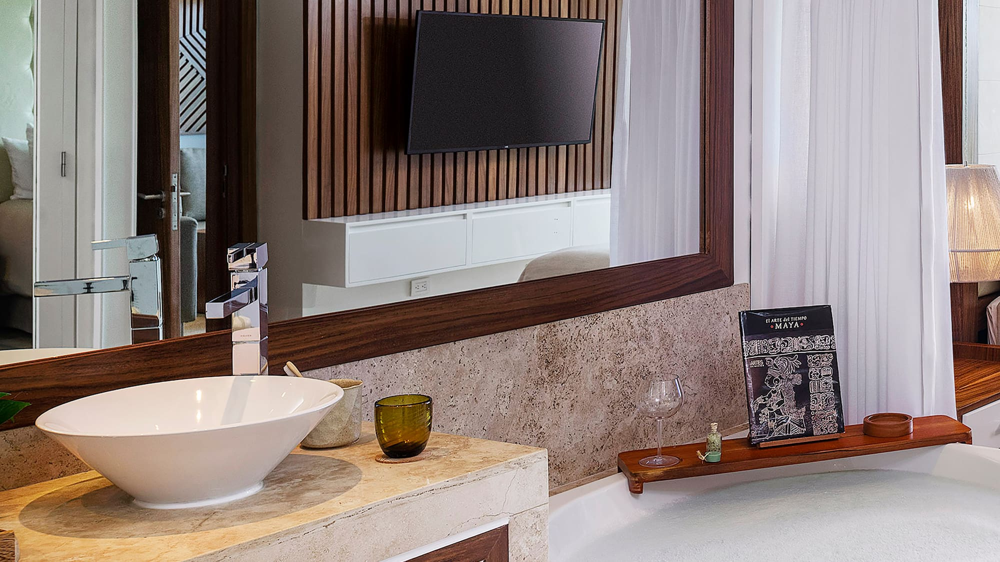 a bathroom with a large mirror and a tub