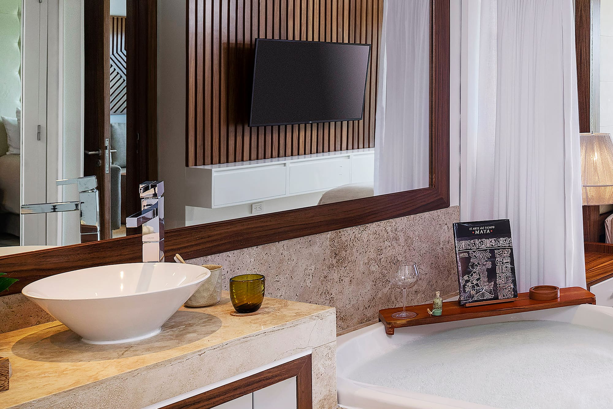 a bathroom with a large mirror and a tub