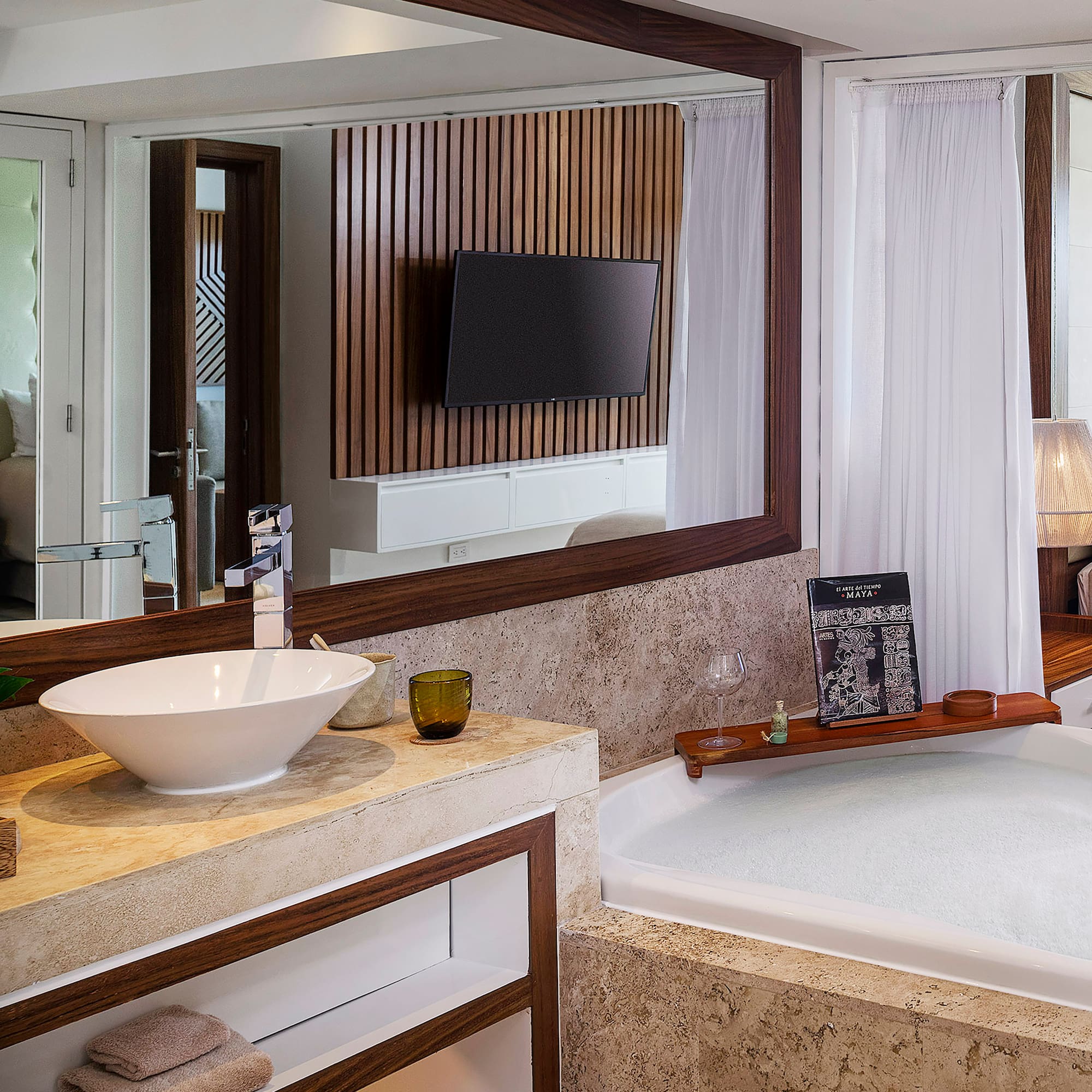 a bathroom with a large mirror and a tub