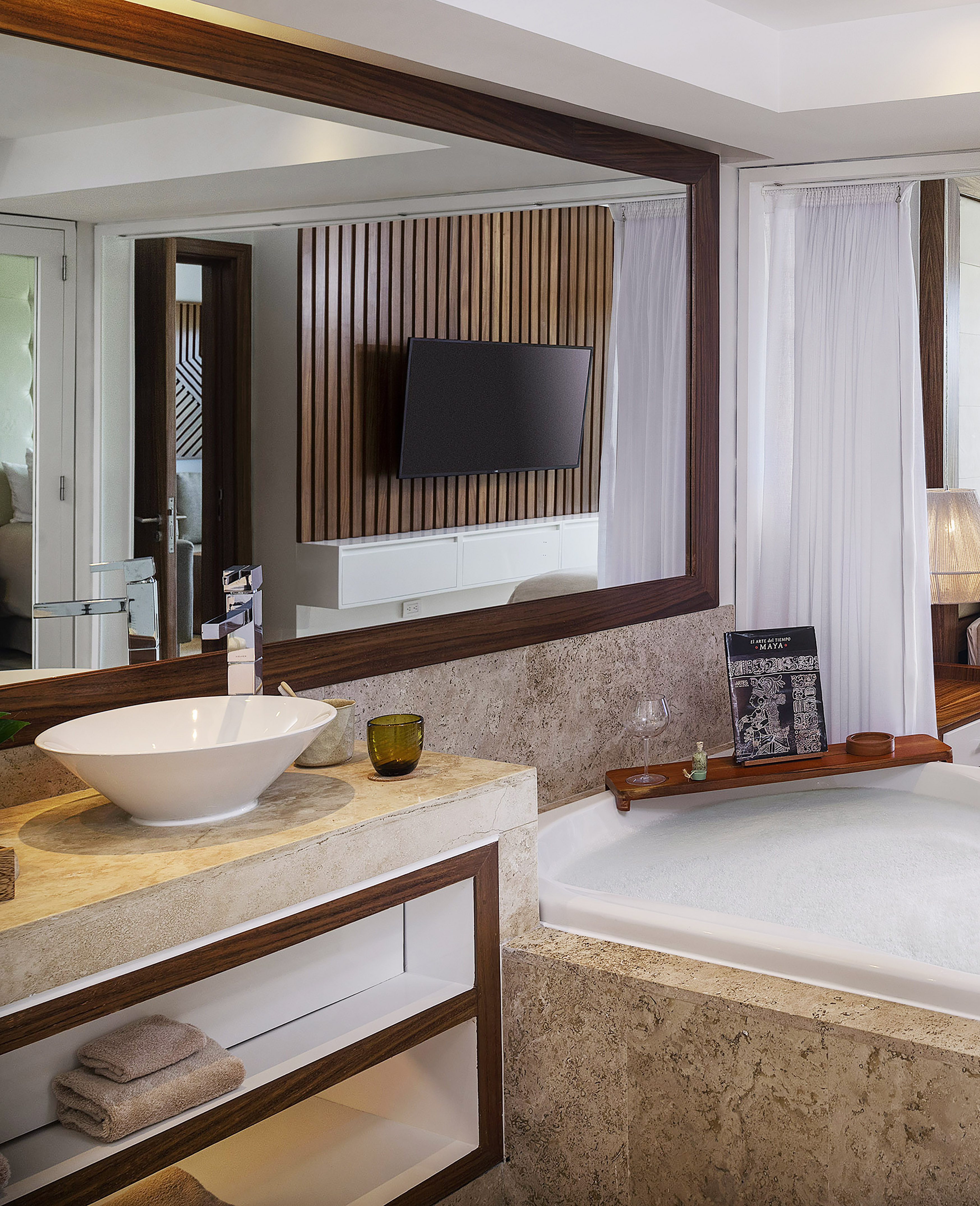 a bathroom with a large mirror and a tub