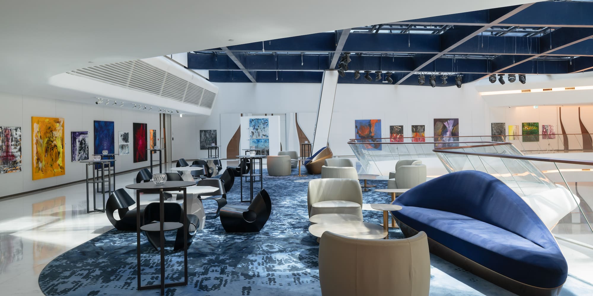 a room with blue carpet and blue couches