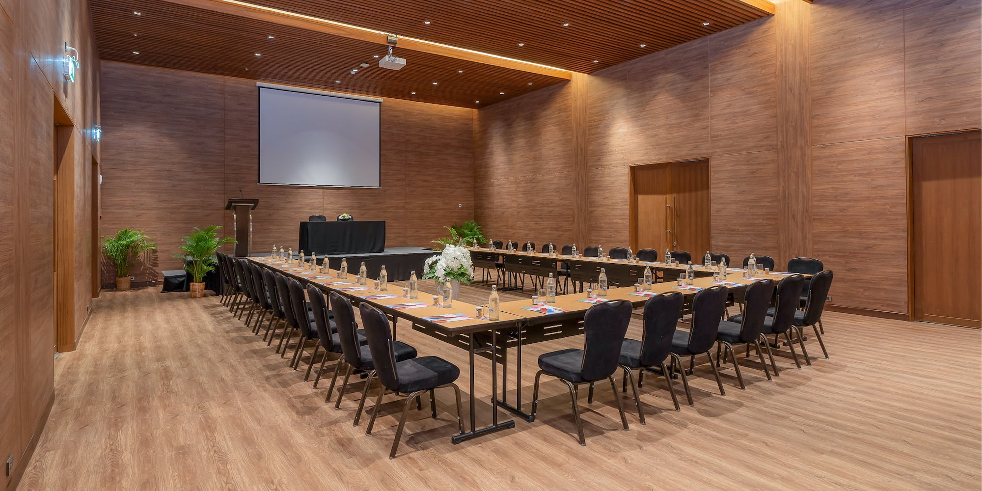 a large conference room with a large screen