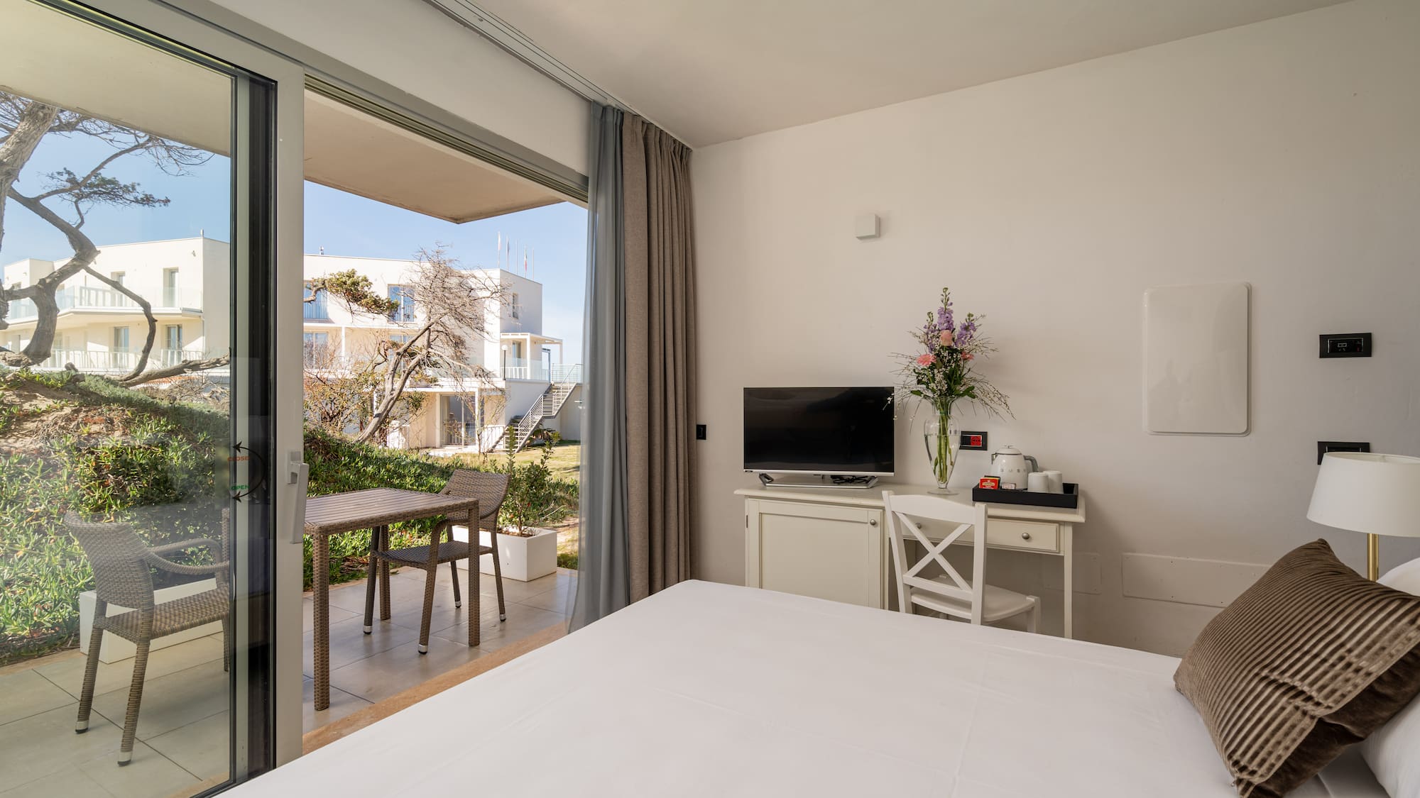 a bedroom with a large glass door