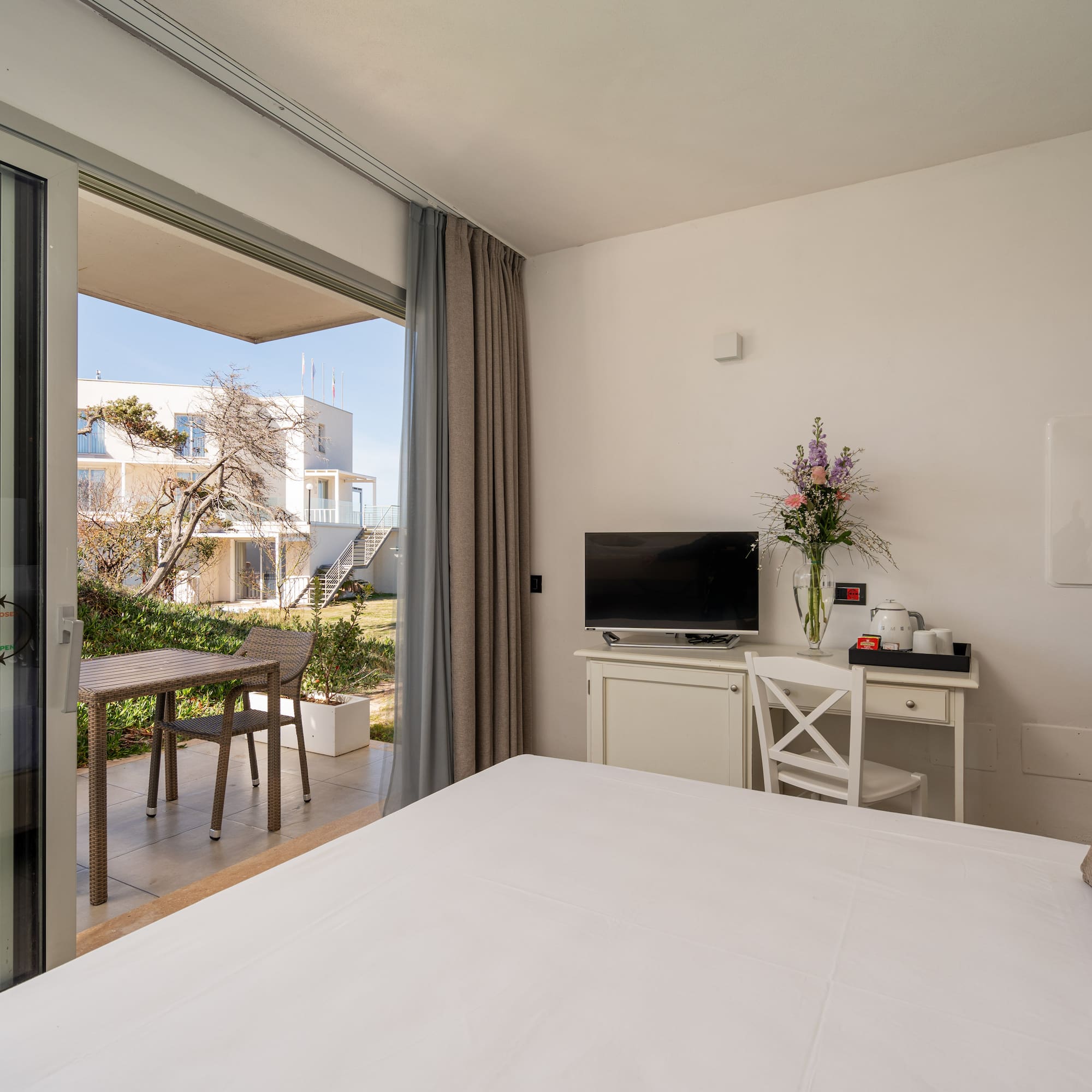 a bedroom with a large glass door