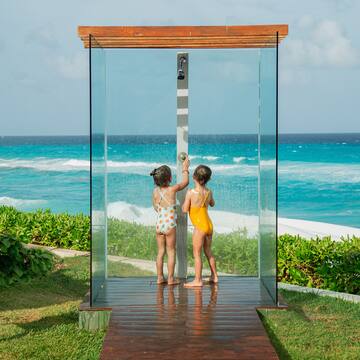 two children standing in a shower