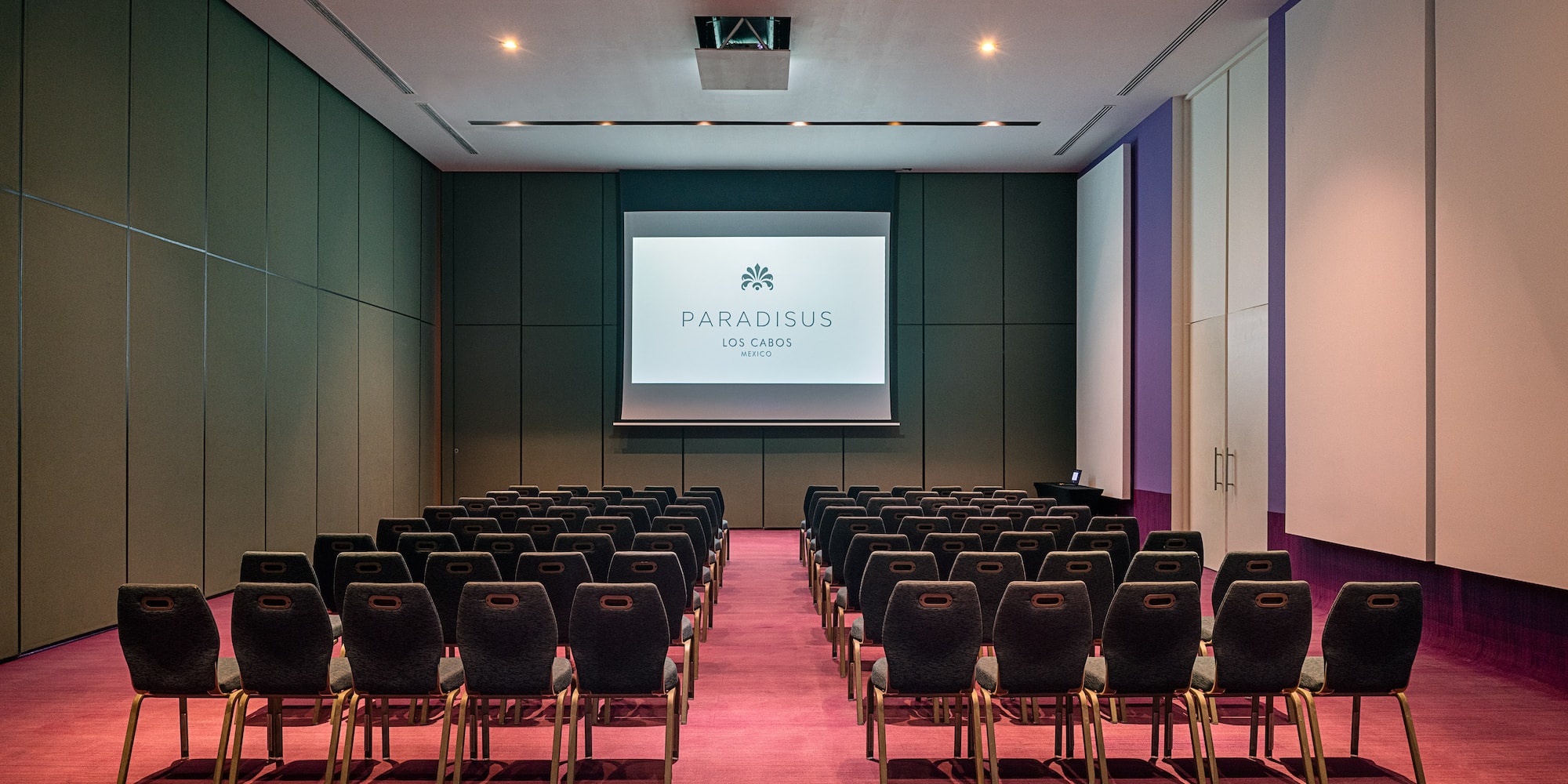 a room with chairs and a projector screen