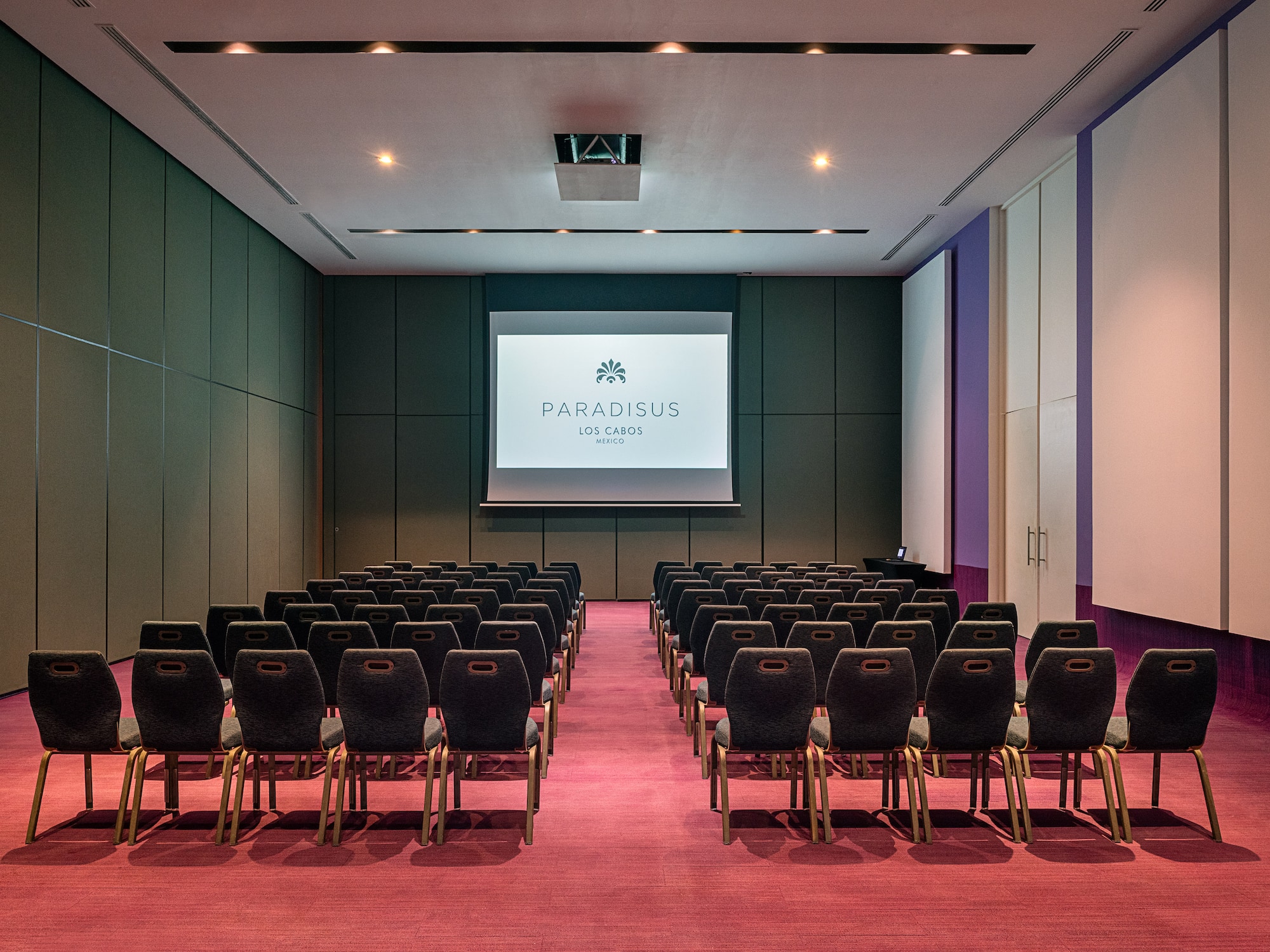 a room with chairs and a projector screen