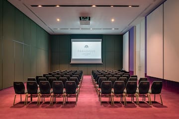 a room with chairs and a projector screen