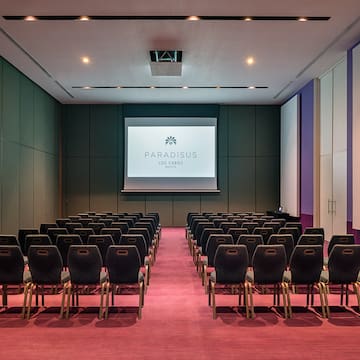 a room with chairs and a projector screen