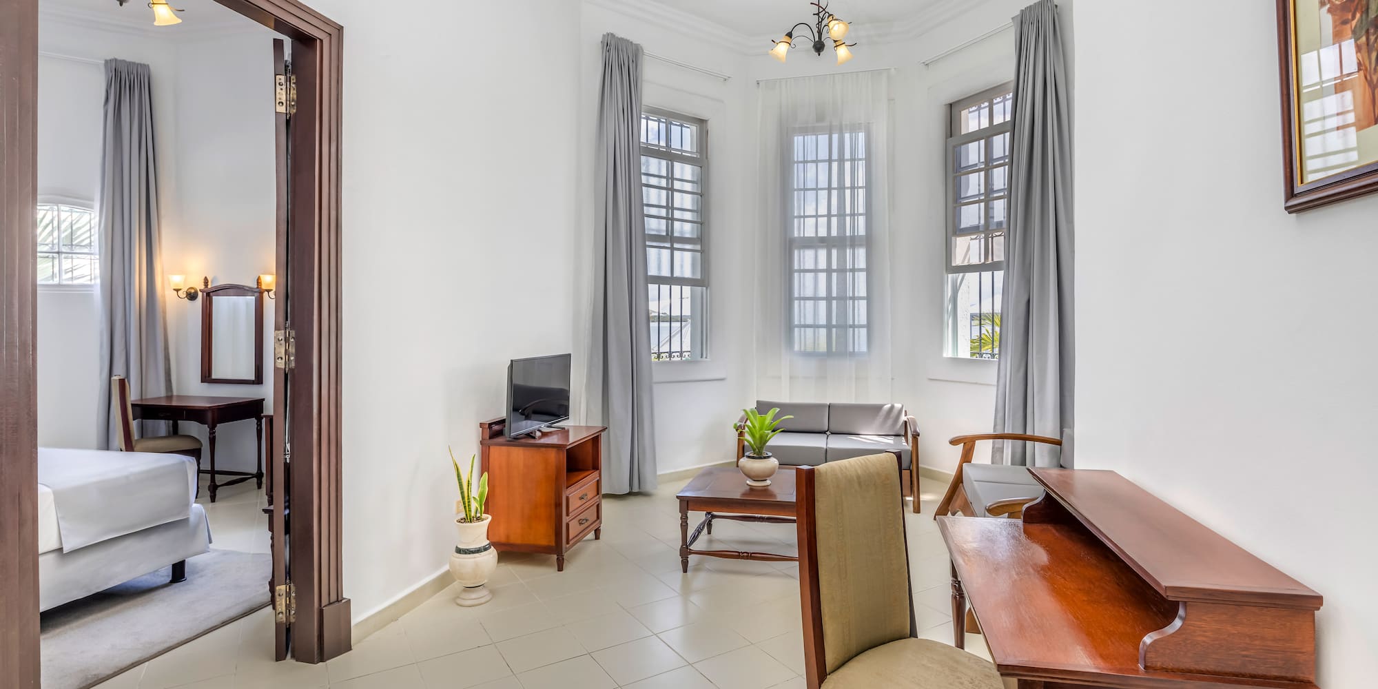 a room with a desk and chairs